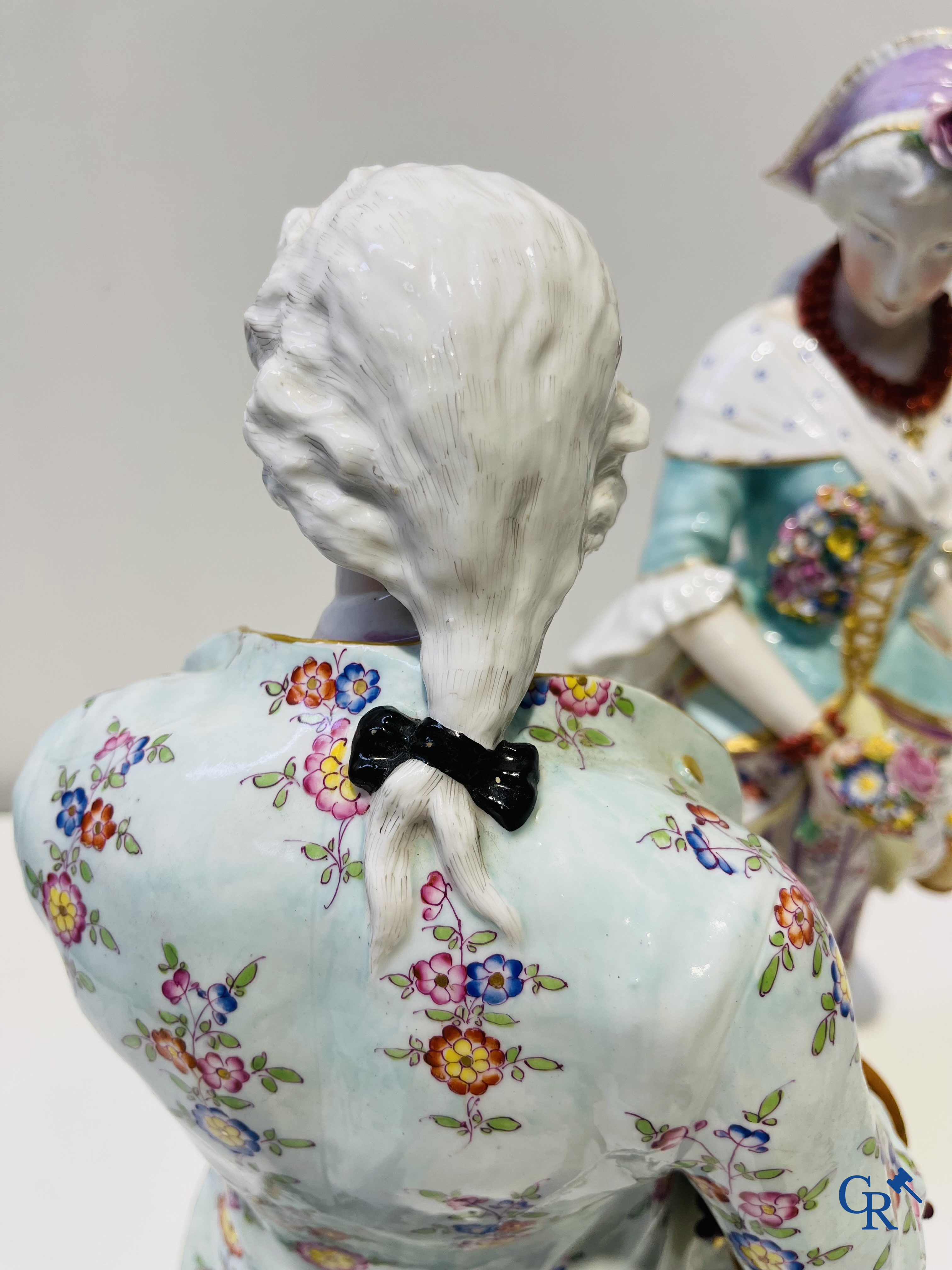 Exceptionally large pair of romantic statues in coloured and gilded porcelain in the manner of Meissen.