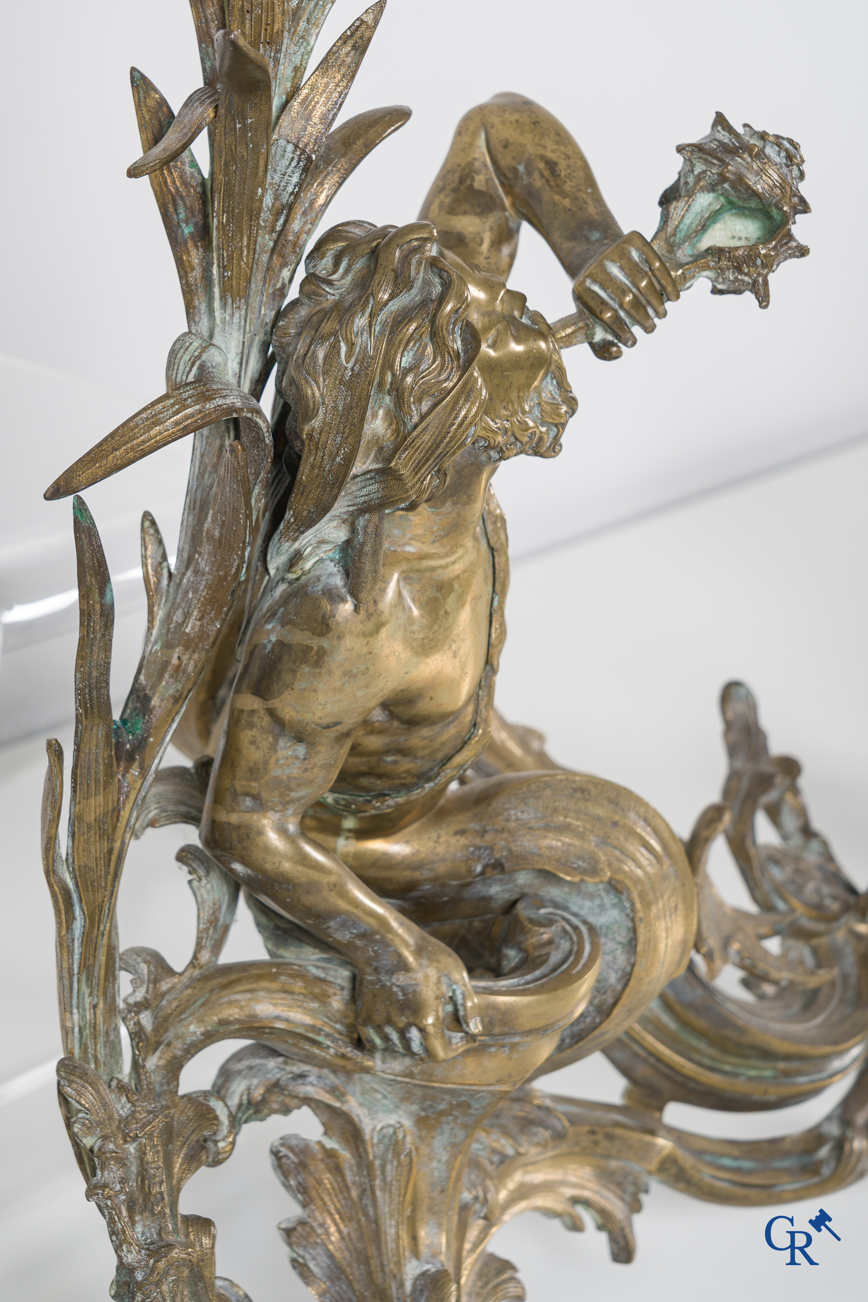 A large pair of finely chiseled bronze chenets with Tritons. Louis XV style. Napoleon III period.