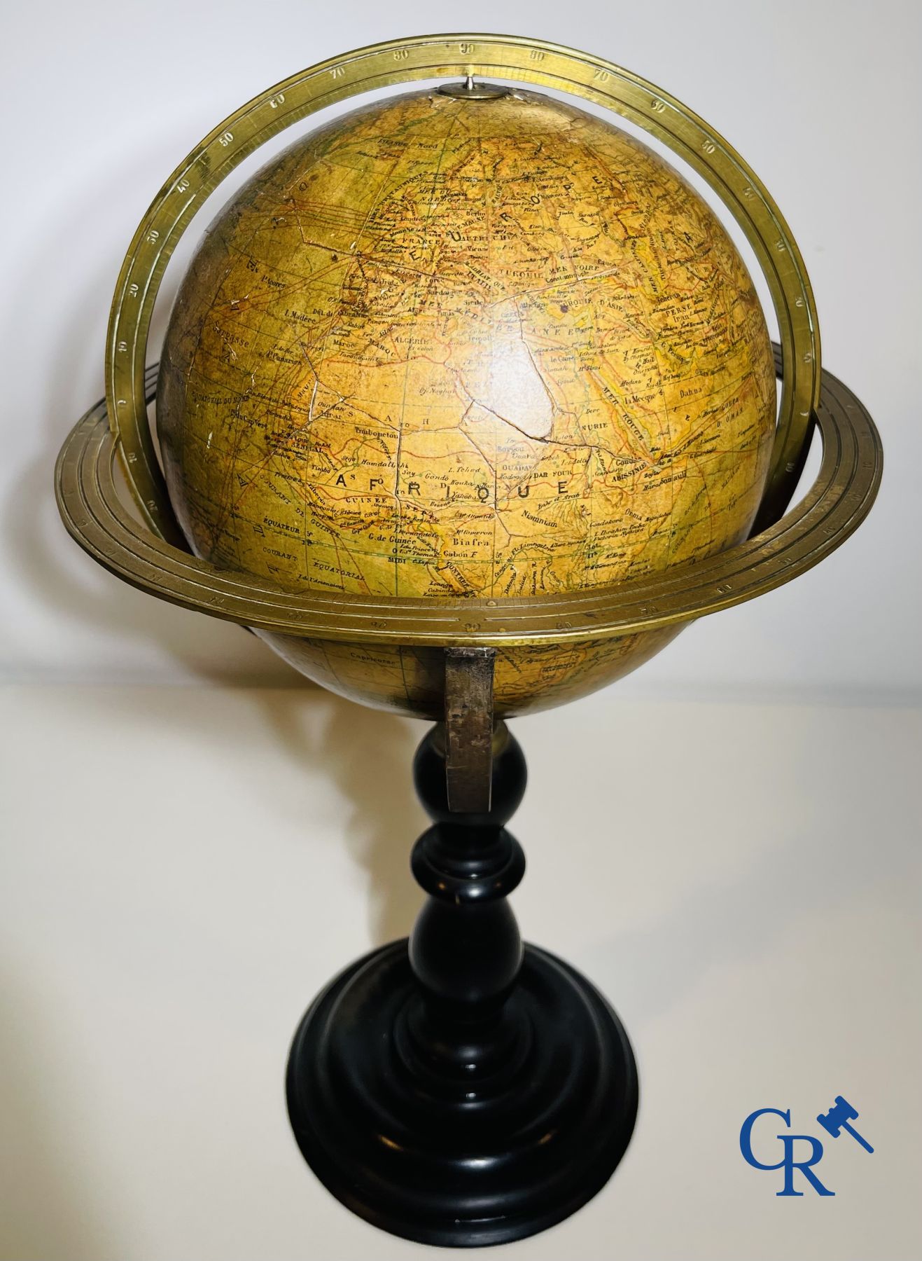 An antique globe with meridian circle on a black lacquered wooden base. 19th century.