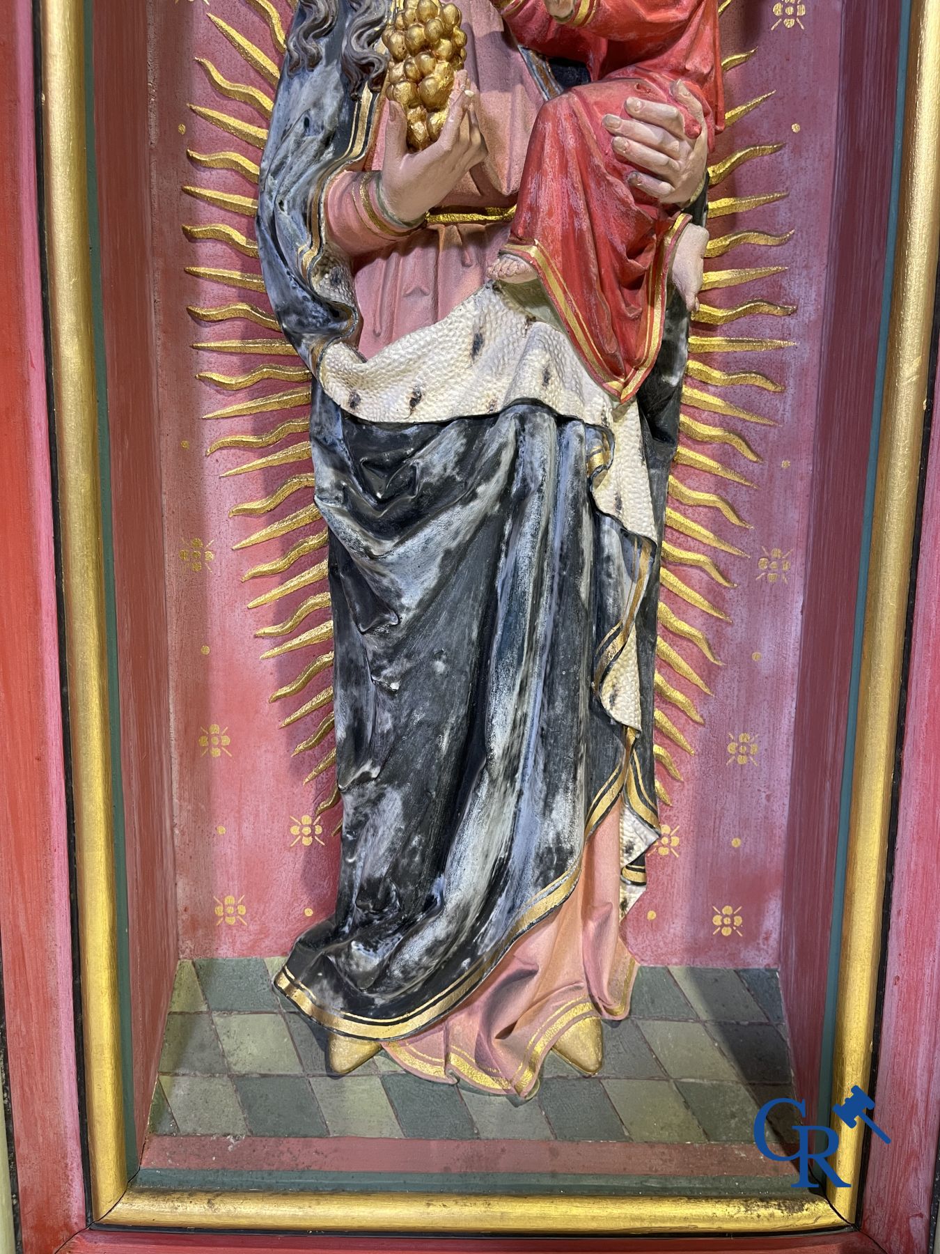 A 19th century wooden statue of Christ and a wooden display case with plaster representation of Mary with child.