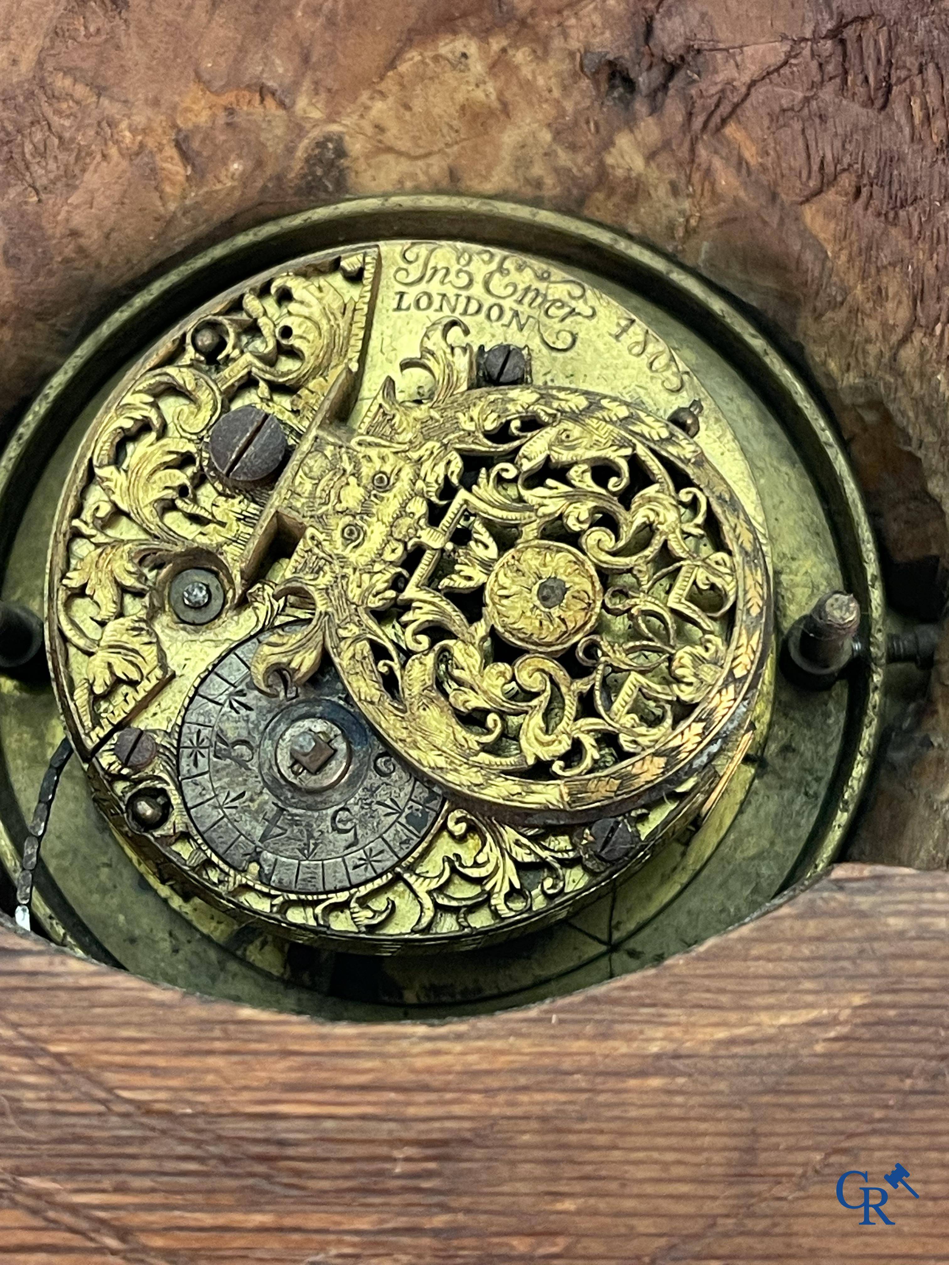 An 18th century wood carved table clock with finely chiseled English watchwork.