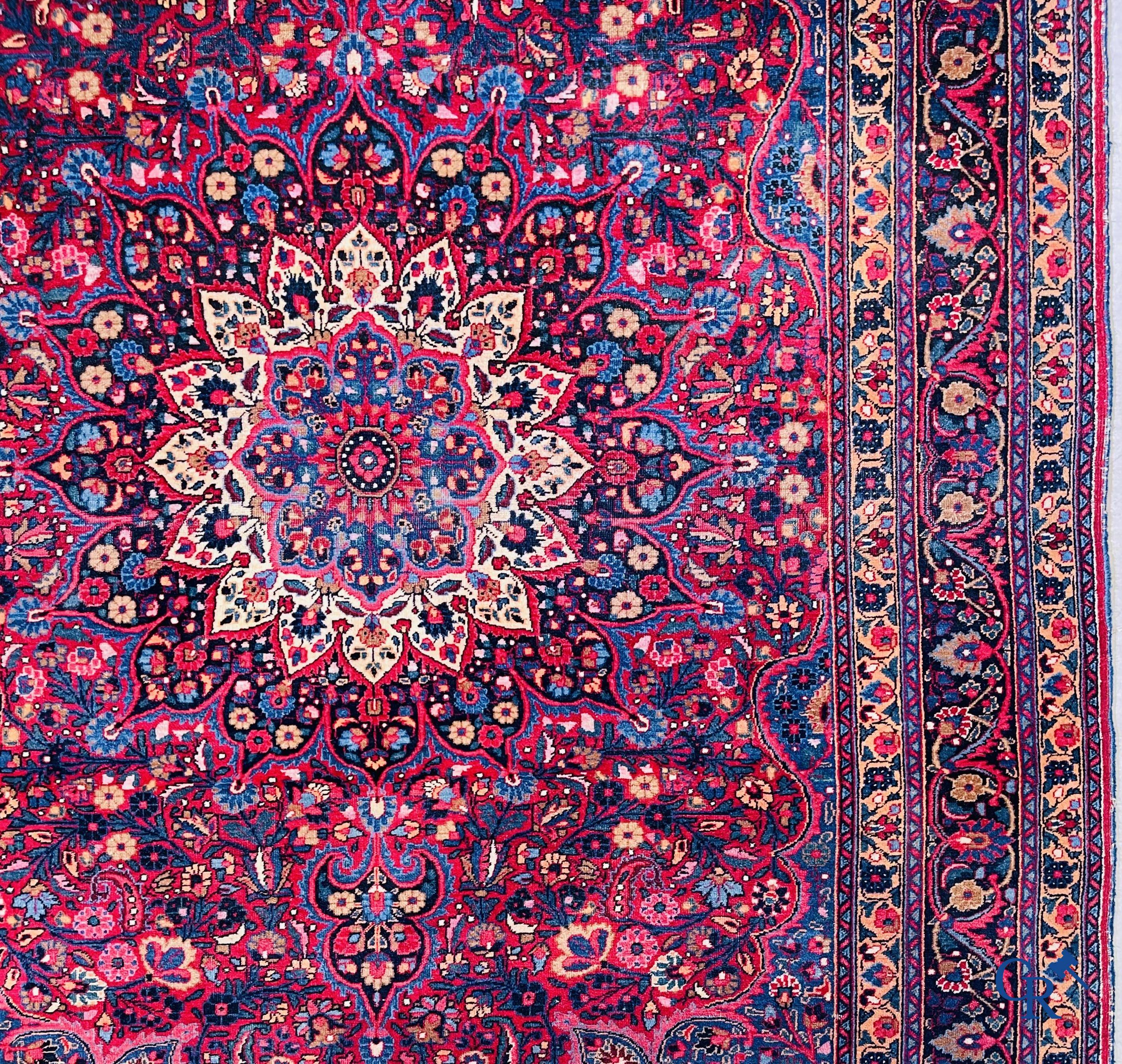 Oriental carpets: Iran, antique Persian carpet with dark red background.