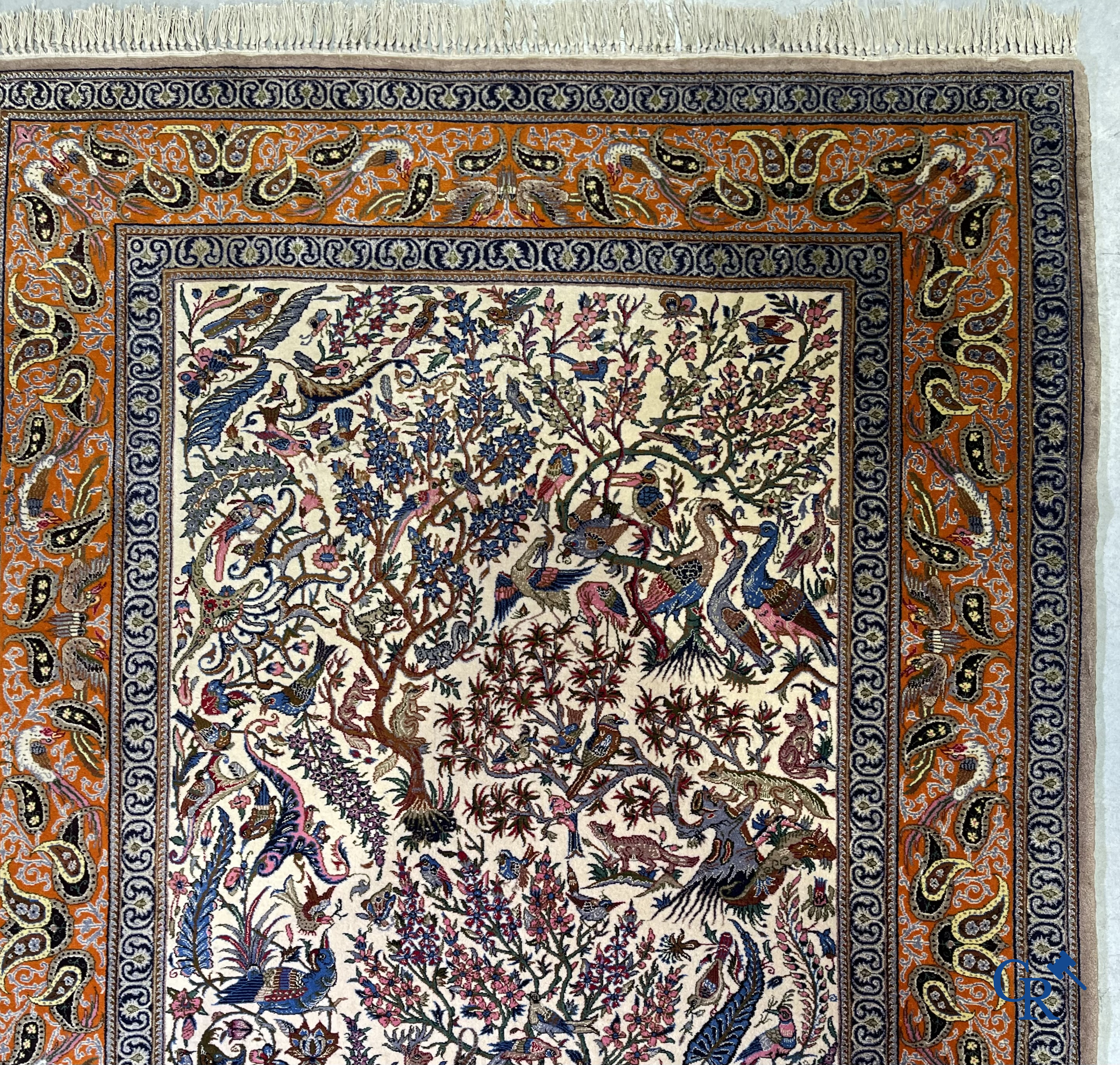 Oriental carpets, a finely hand-knotted silk carpet with forest animals. Signed.