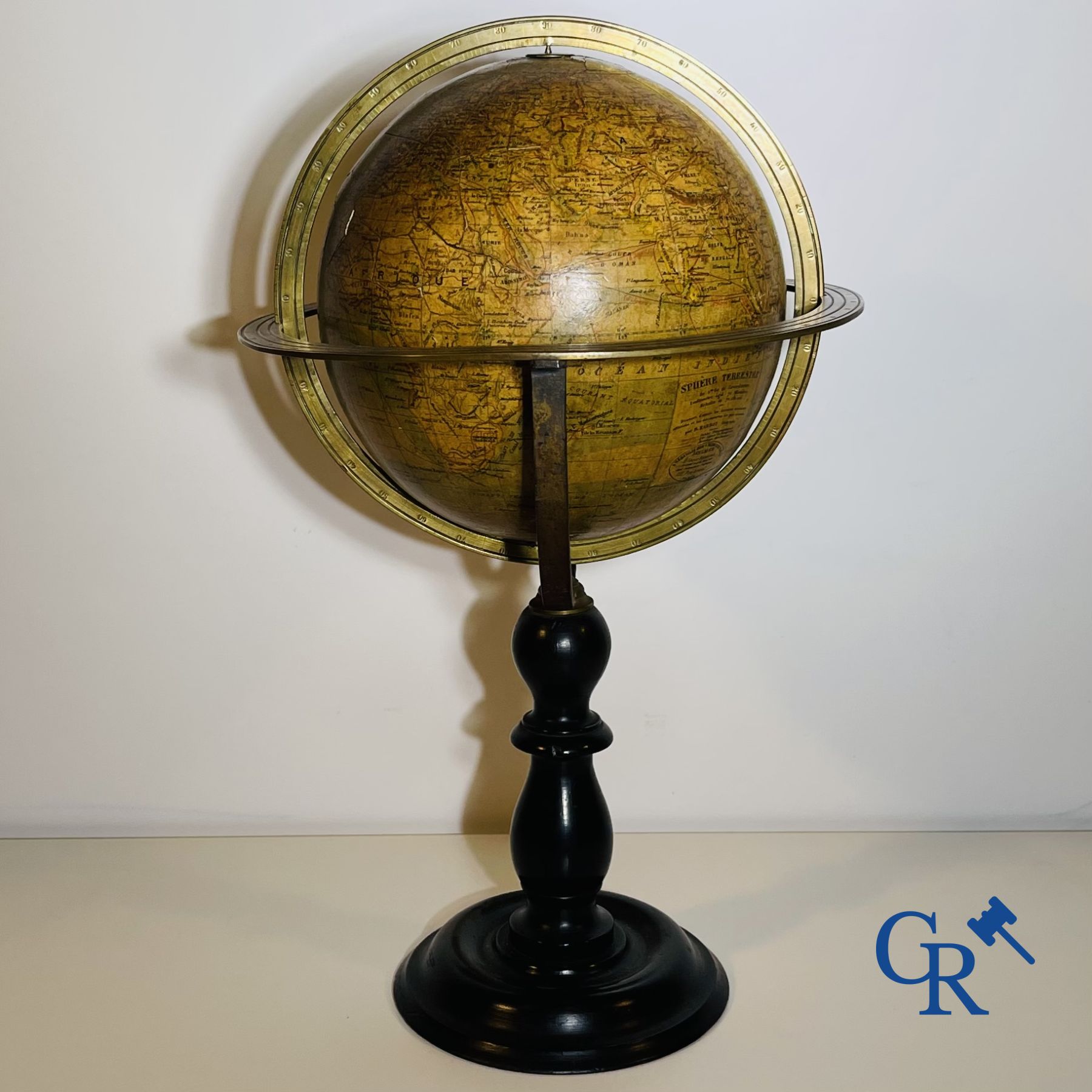 An antique globe with meridian circle on a black lacquered wooden base. 19th century.