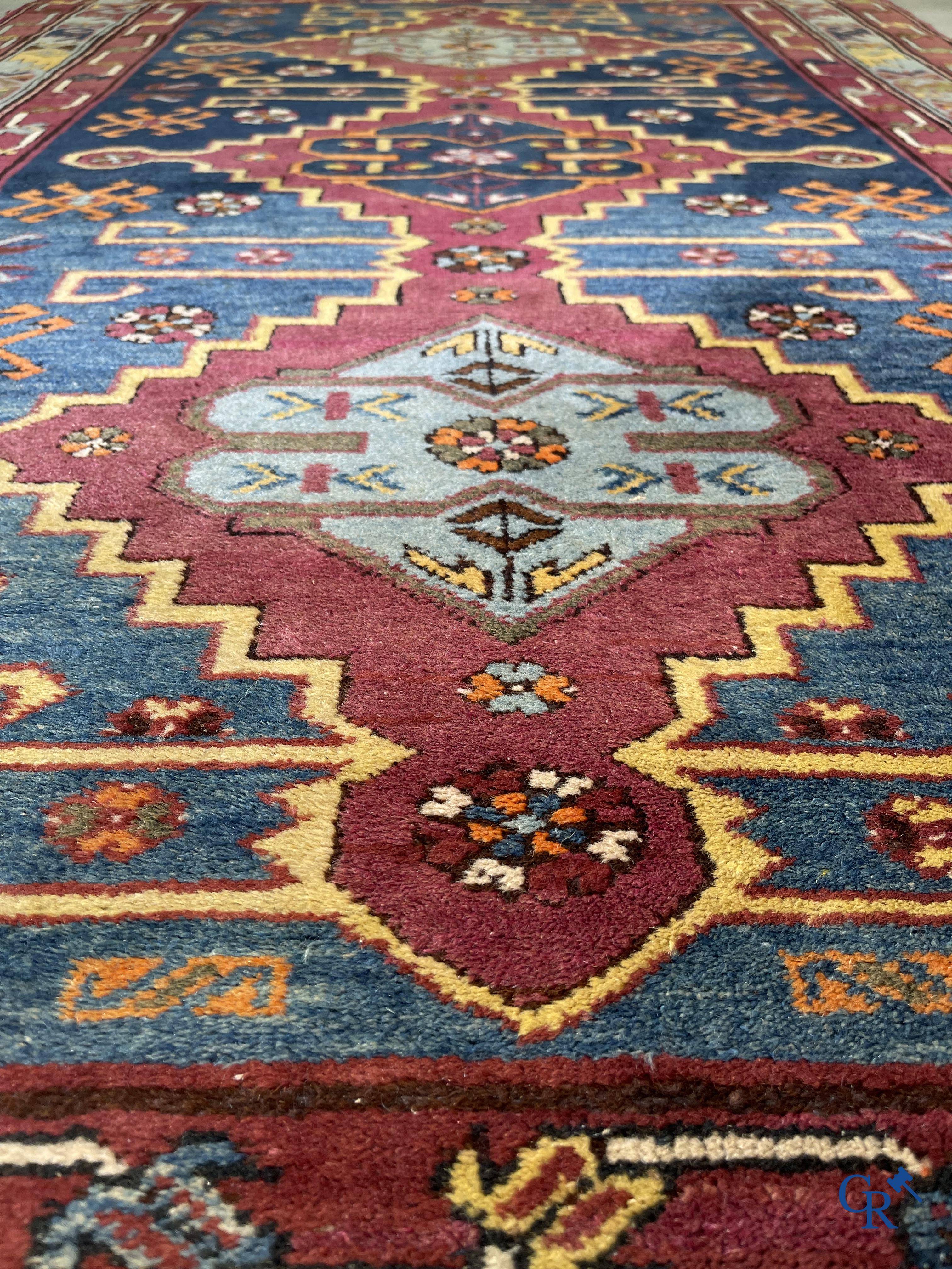 Oriental carpets, an antique hand-knotted Oriental carpet with motifs on a blue background.