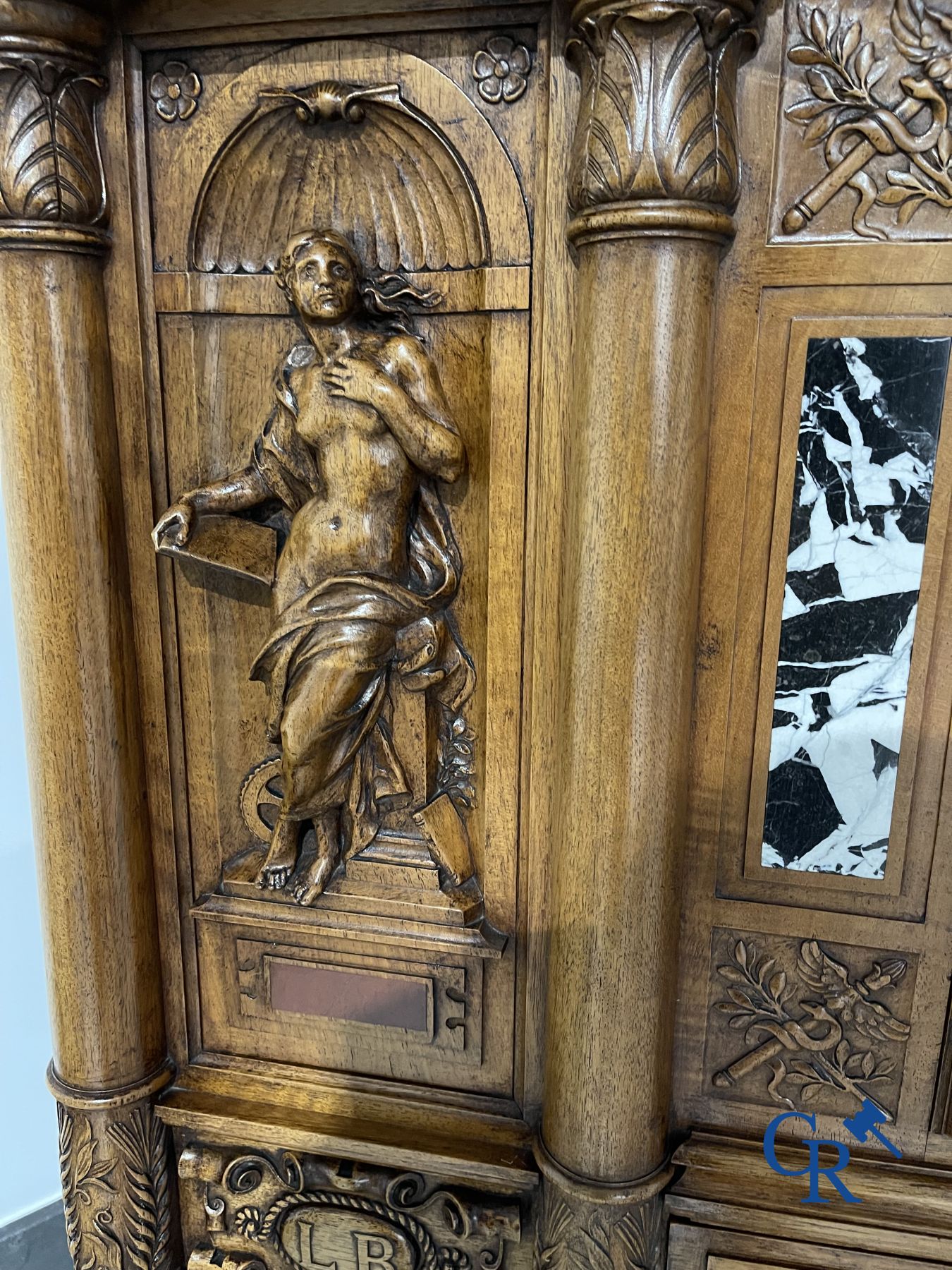 Furniture: A finely carved walnut credence in neo renaissance style with marble inlay.