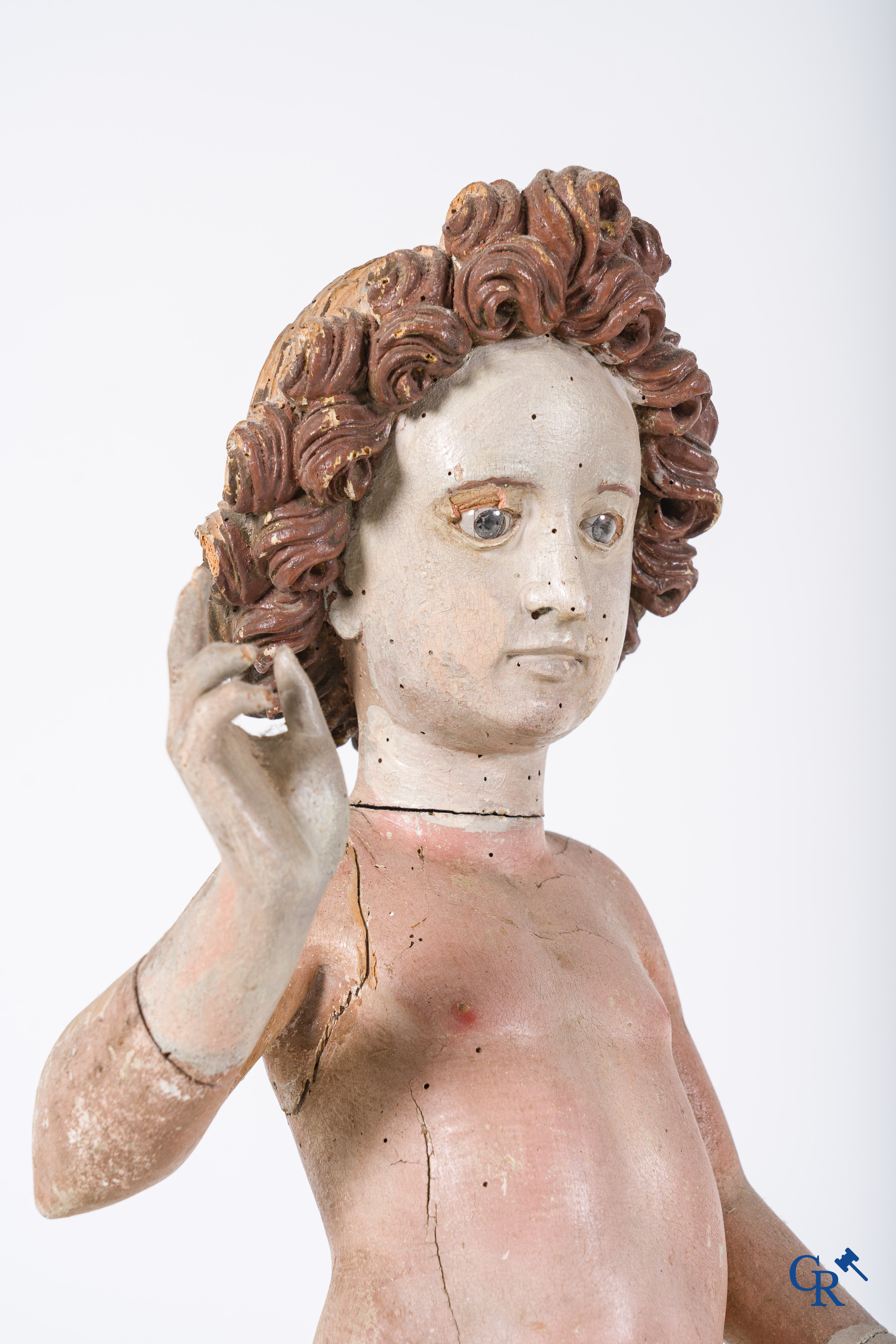 Religious objects. A polychrome wood sculpture depicting the child Jesus in Salvator Mundi. 17th-18th century.