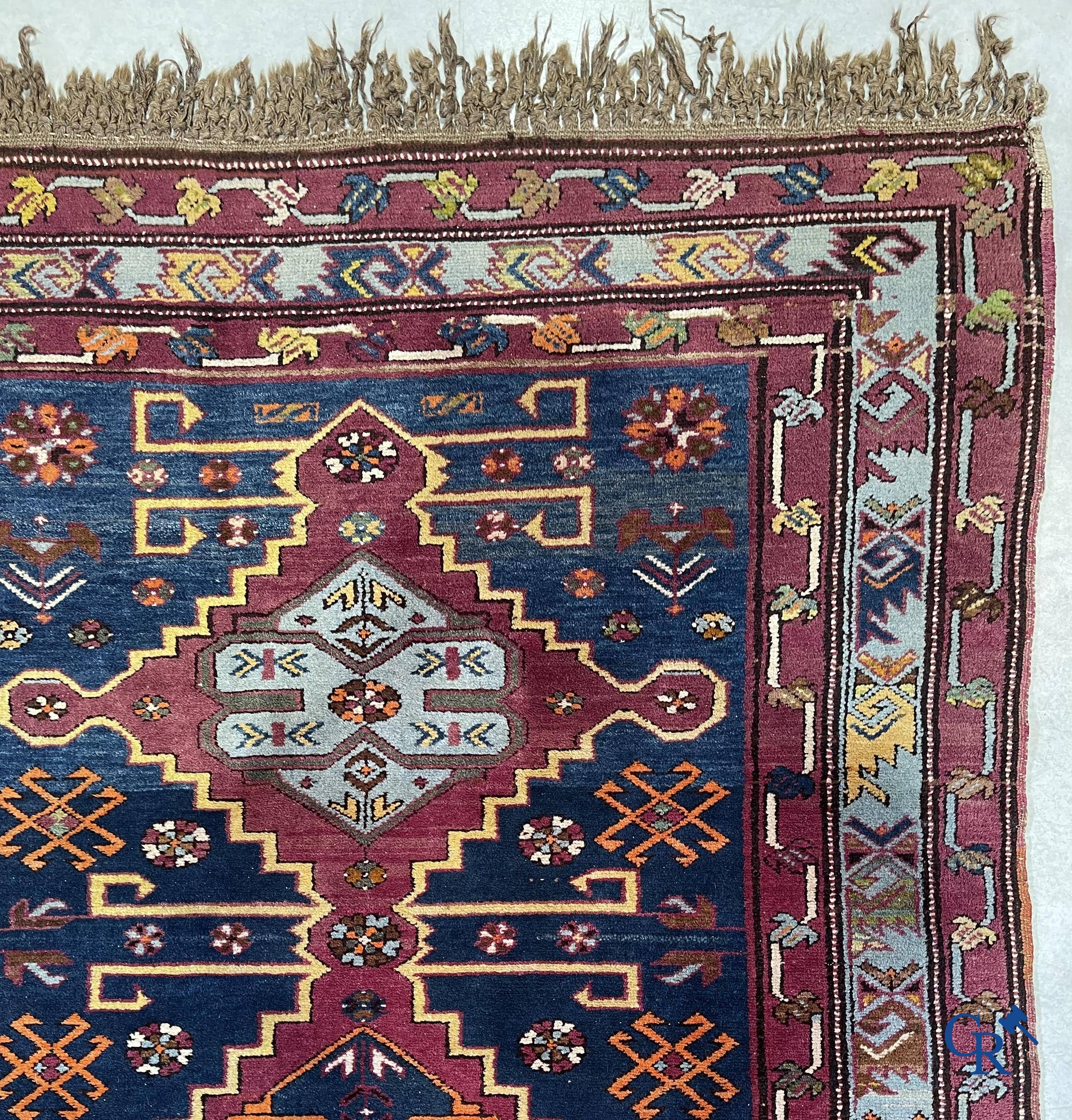 Oriental carpets, an antique hand-knotted Oriental carpet with motifs on a blue background.