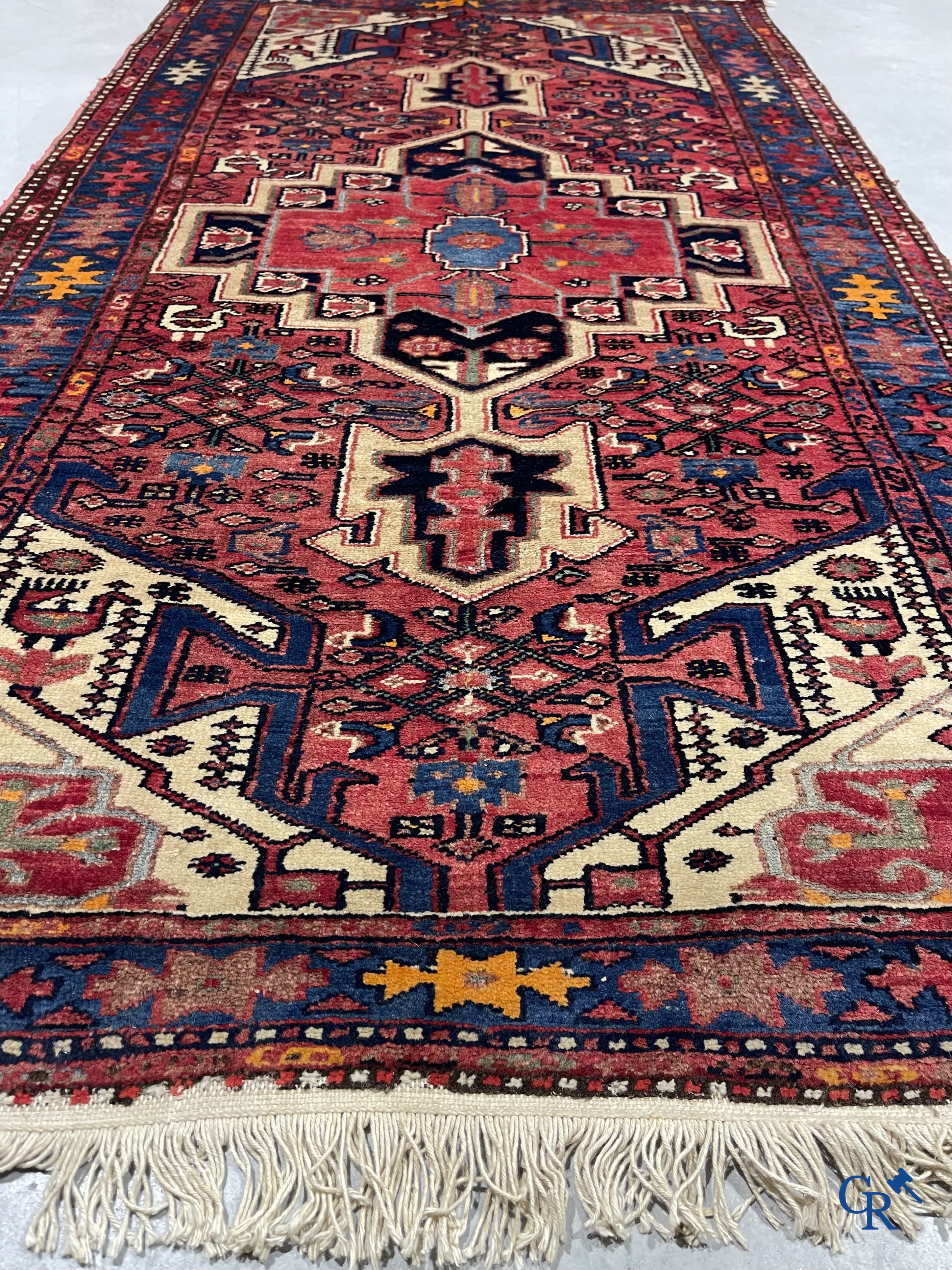 Oriental carpets. Antique hand-knotted Persian carpet with dark red background.