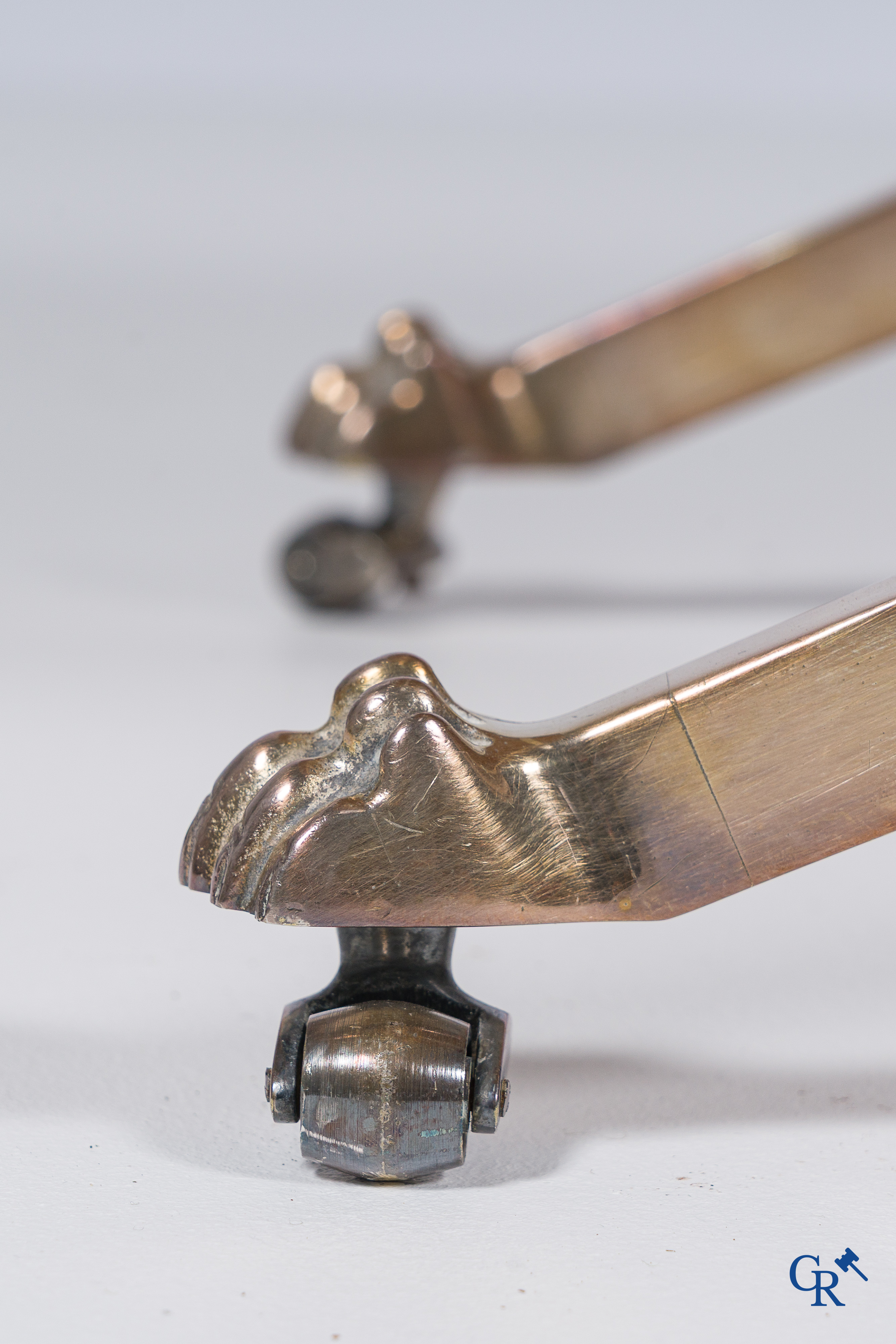 Side table in silver-plated brass, X-shaped legs, finished with lion legs. Around 1960.