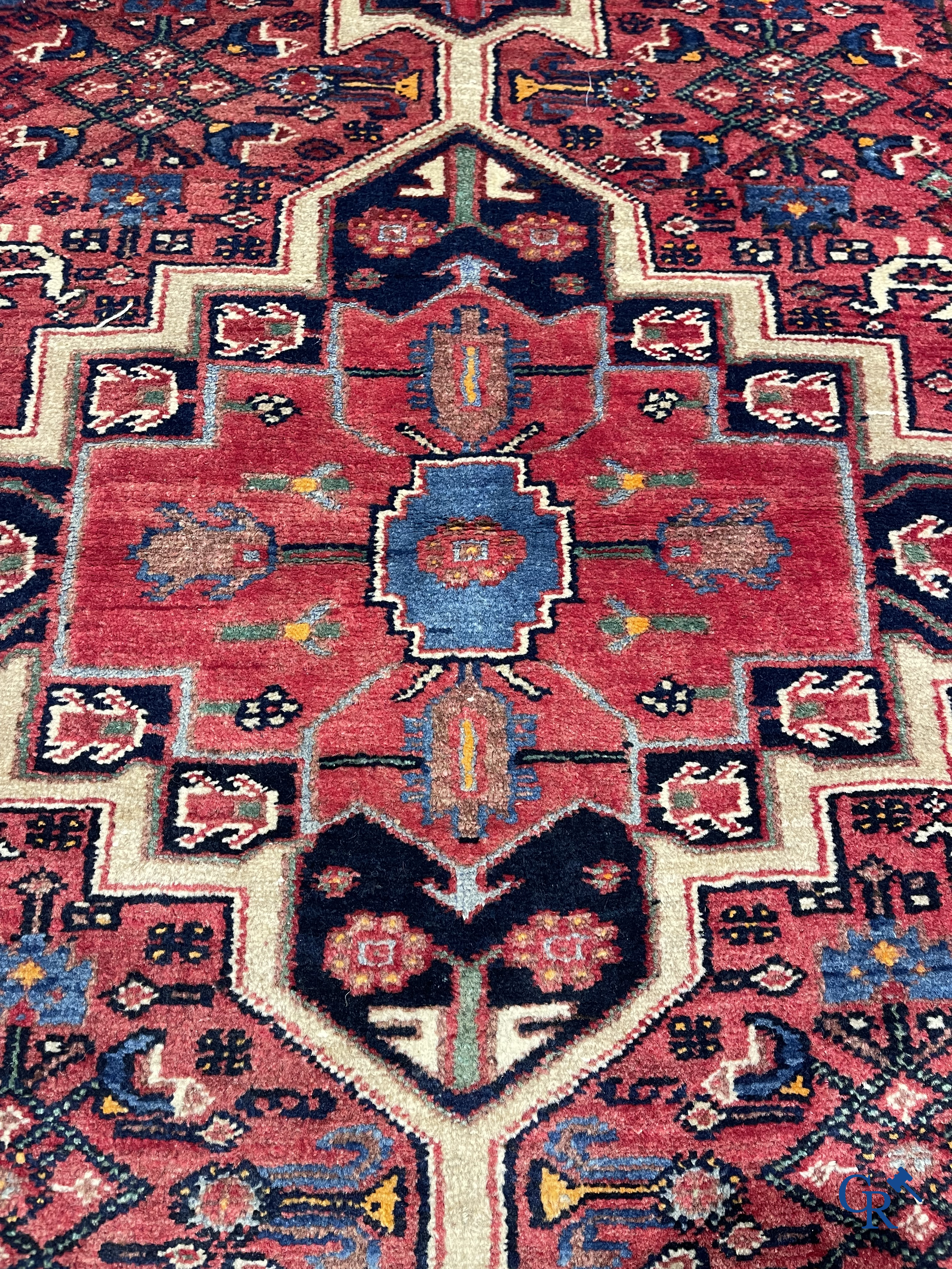 Oriental carpets. Antique hand-knotted Persian carpet with dark red background.