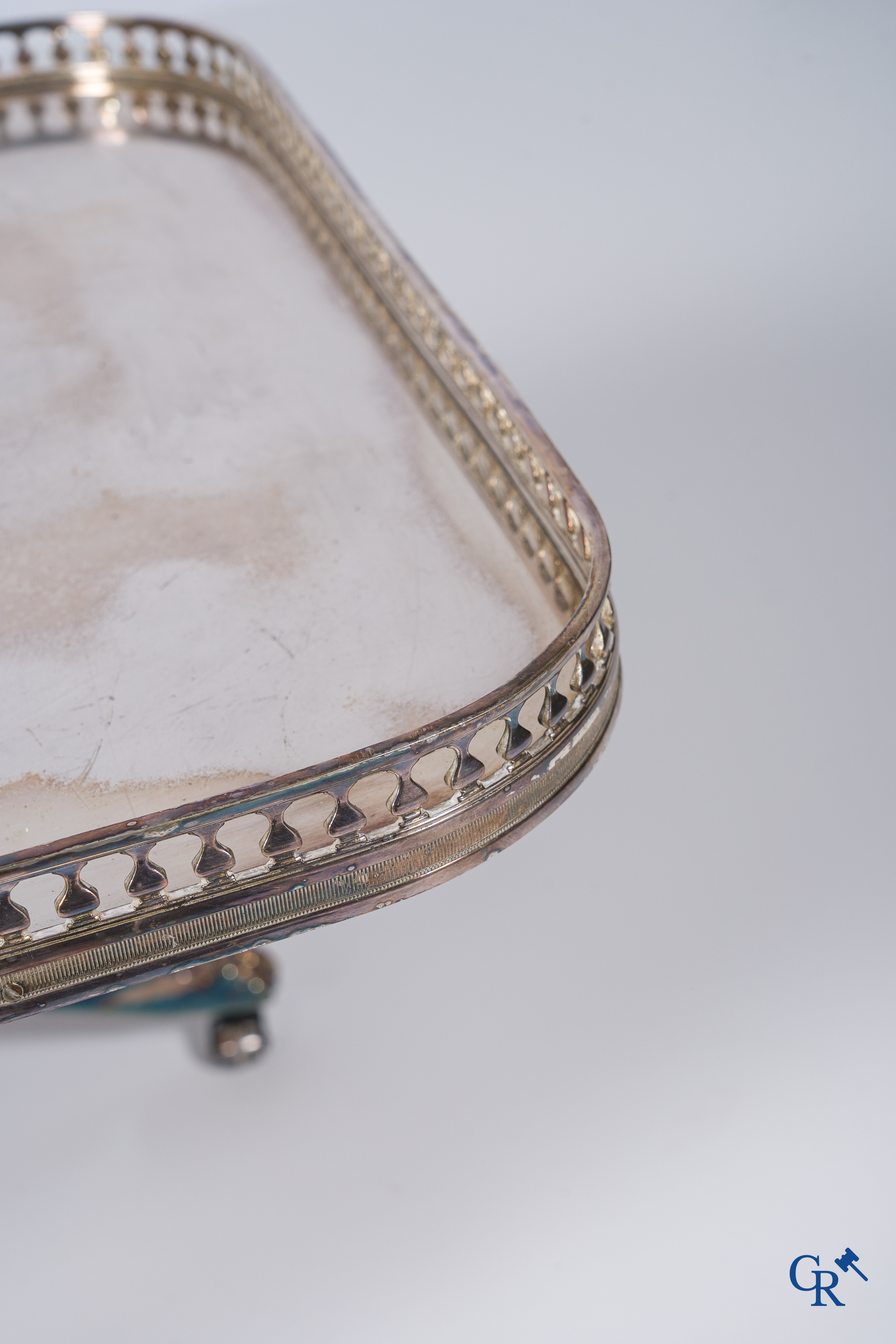 Side table in silver-plated brass, X-shaped legs, finished with lion legs. Around 1960.