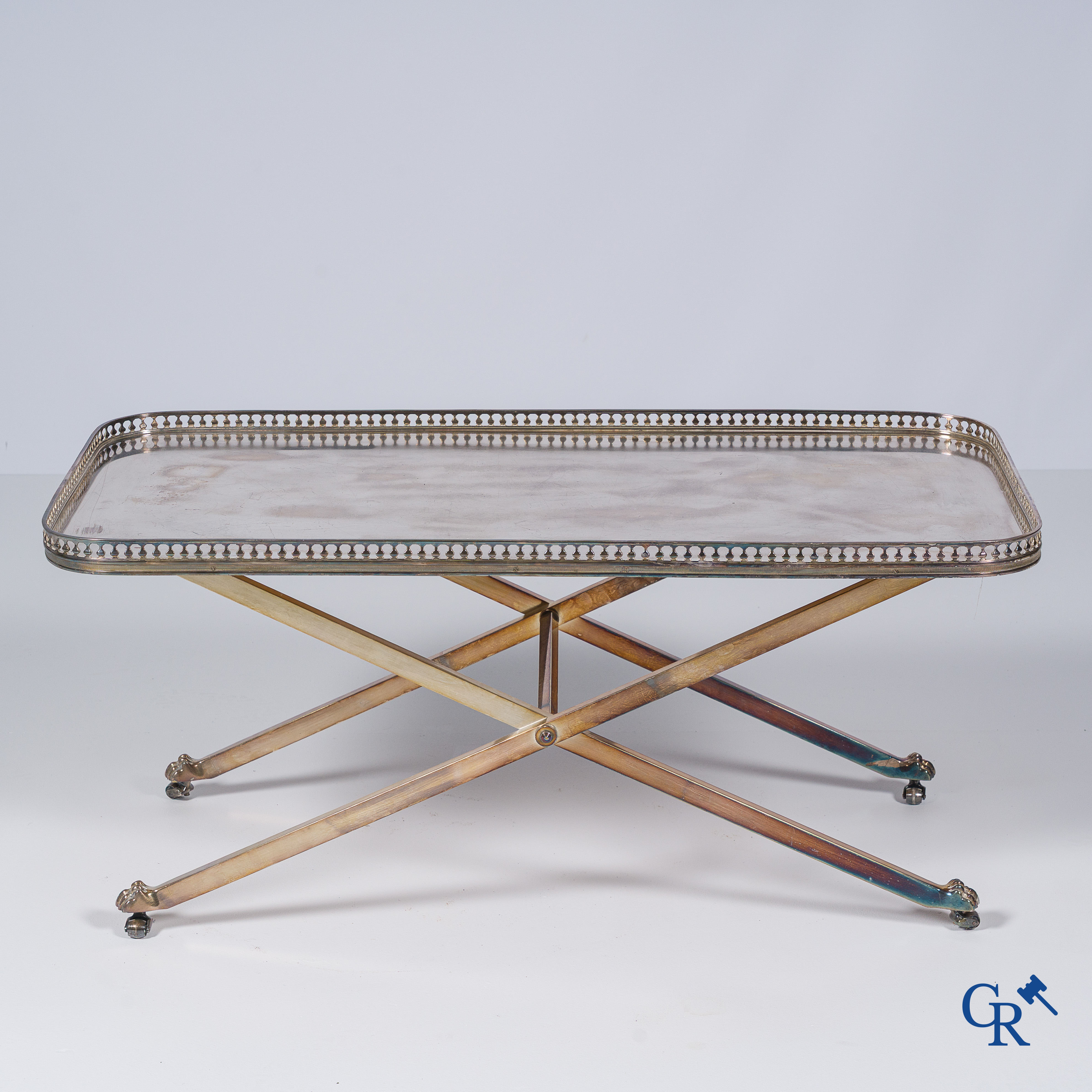 Bijzettafel in verzilverd messing, X-vormige poten, afgewerkt met leeuwenpootjes. Circa 1960.