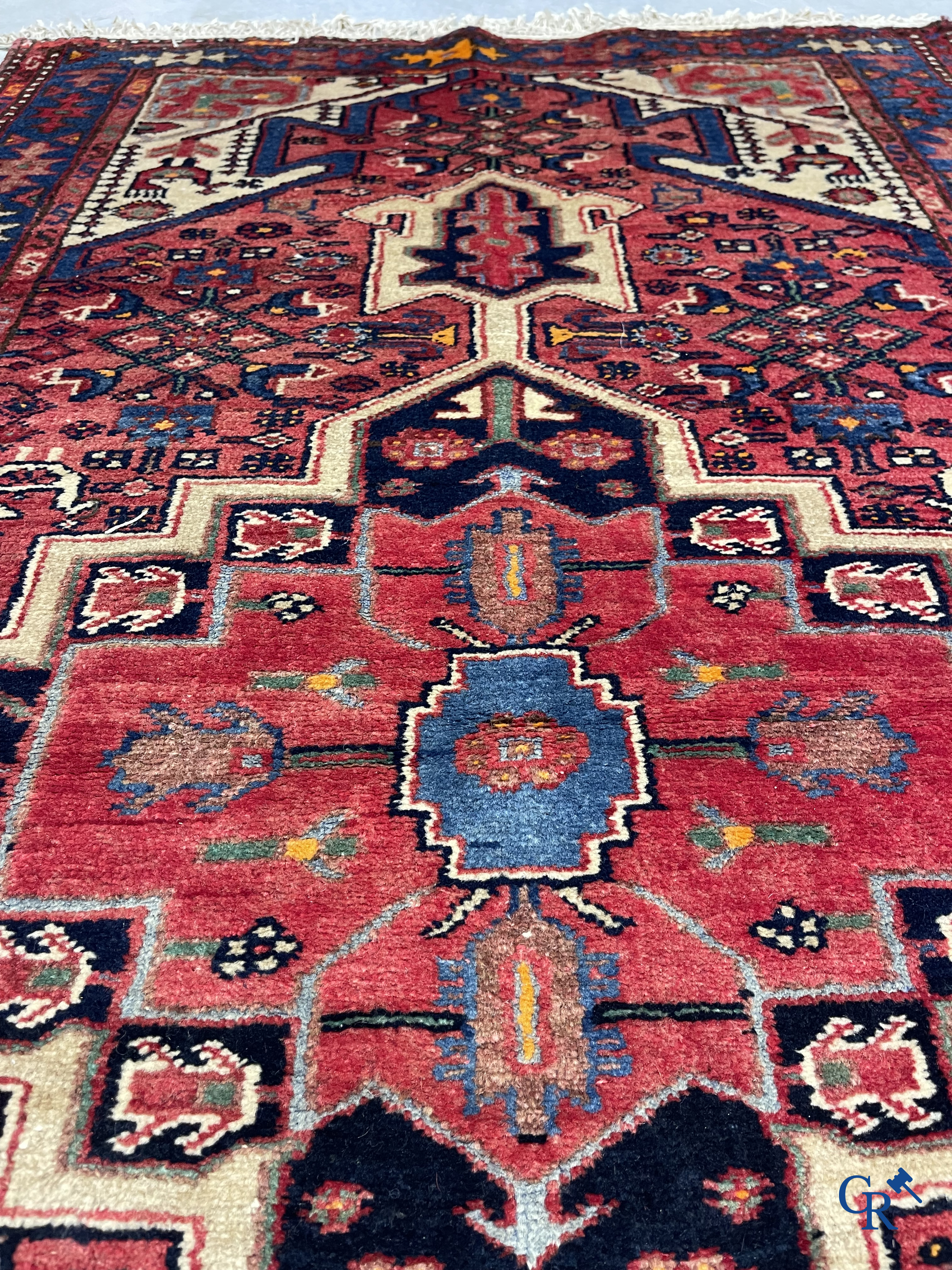 Oriental carpets. Antique hand-knotted Persian carpet with dark red background.