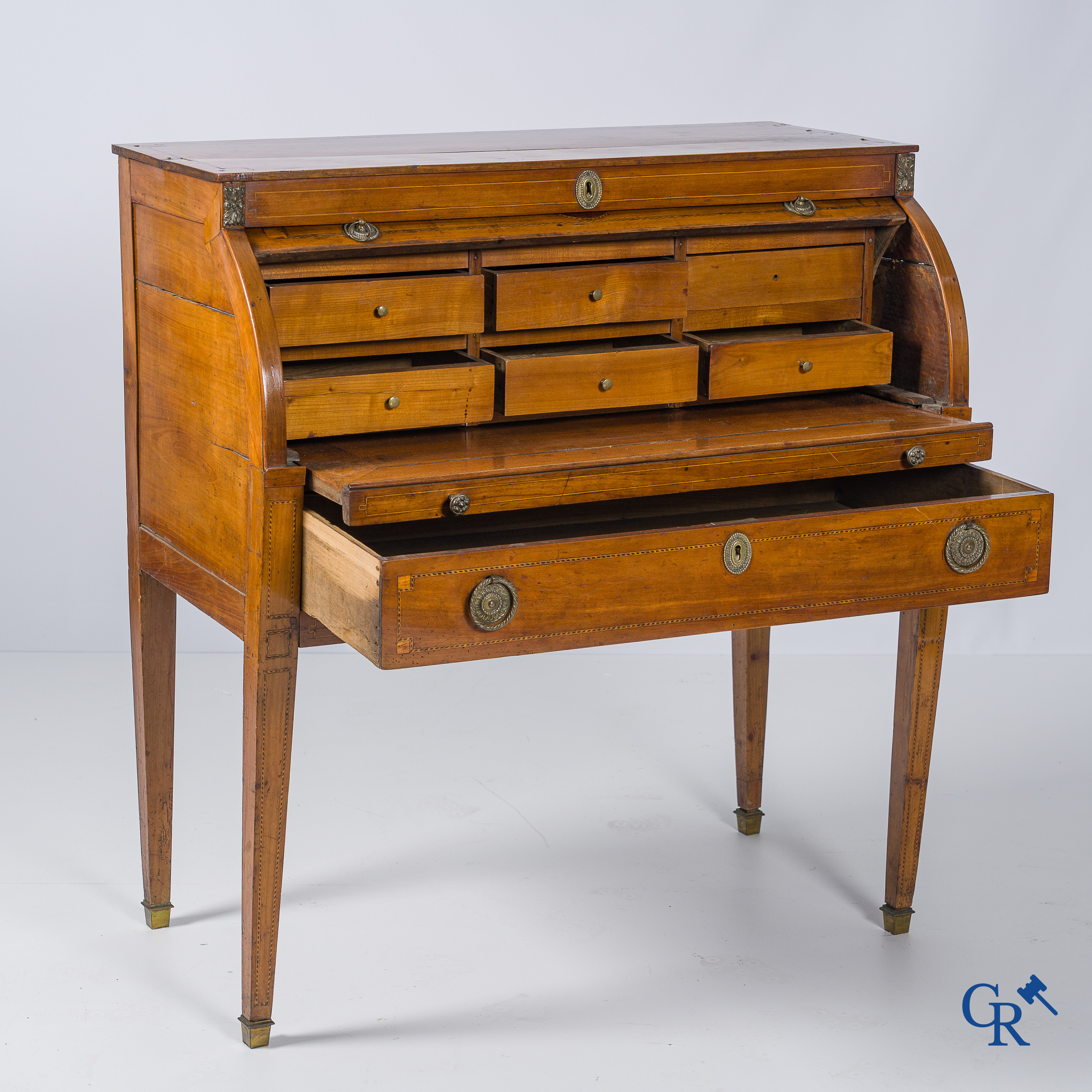 LXVI-period. A ladies cylinder desk in cherrywood and marquetry. France, end of the 18th century.