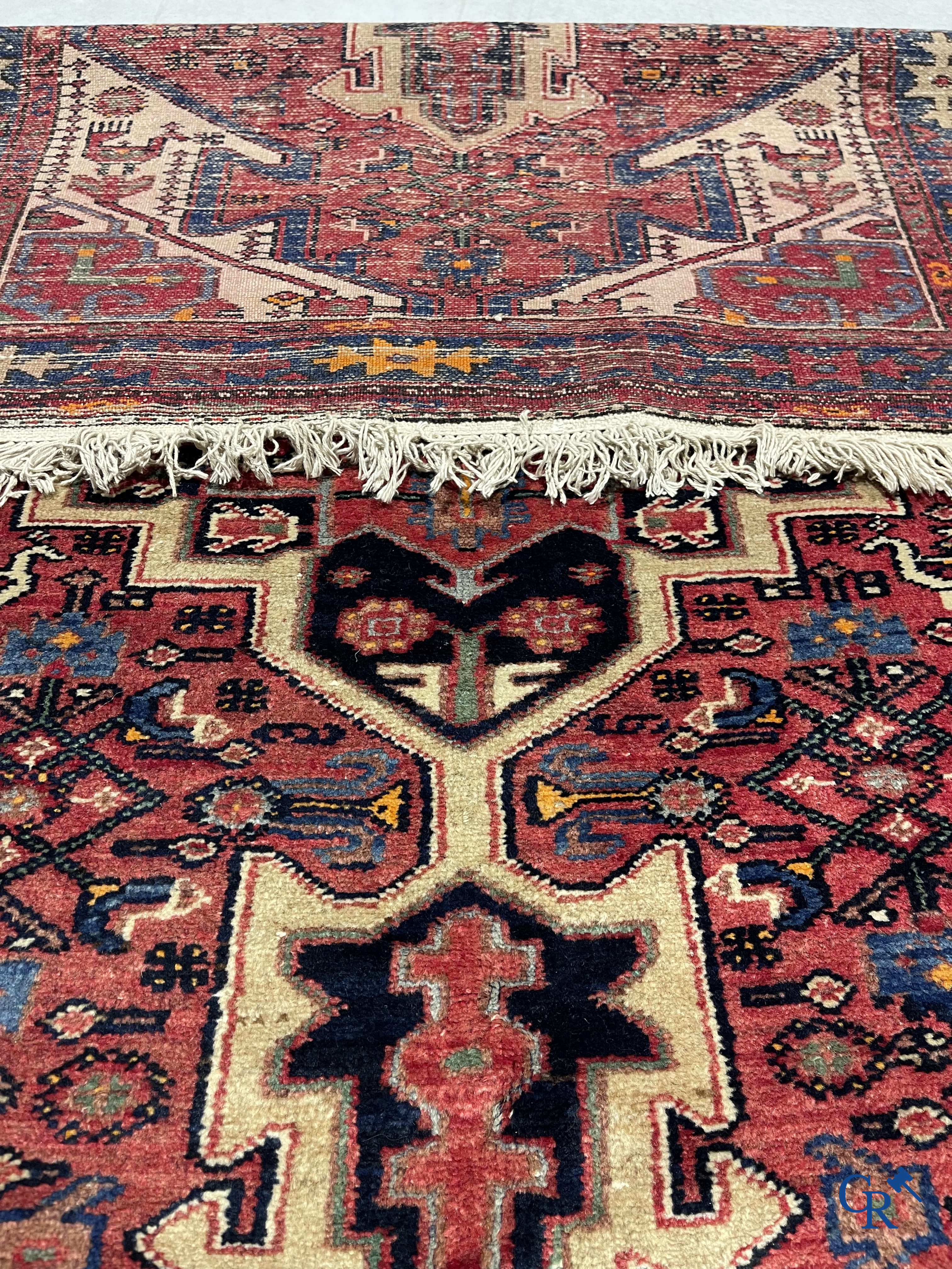 Oriental carpets. Antique hand-knotted Persian carpet with dark red background.