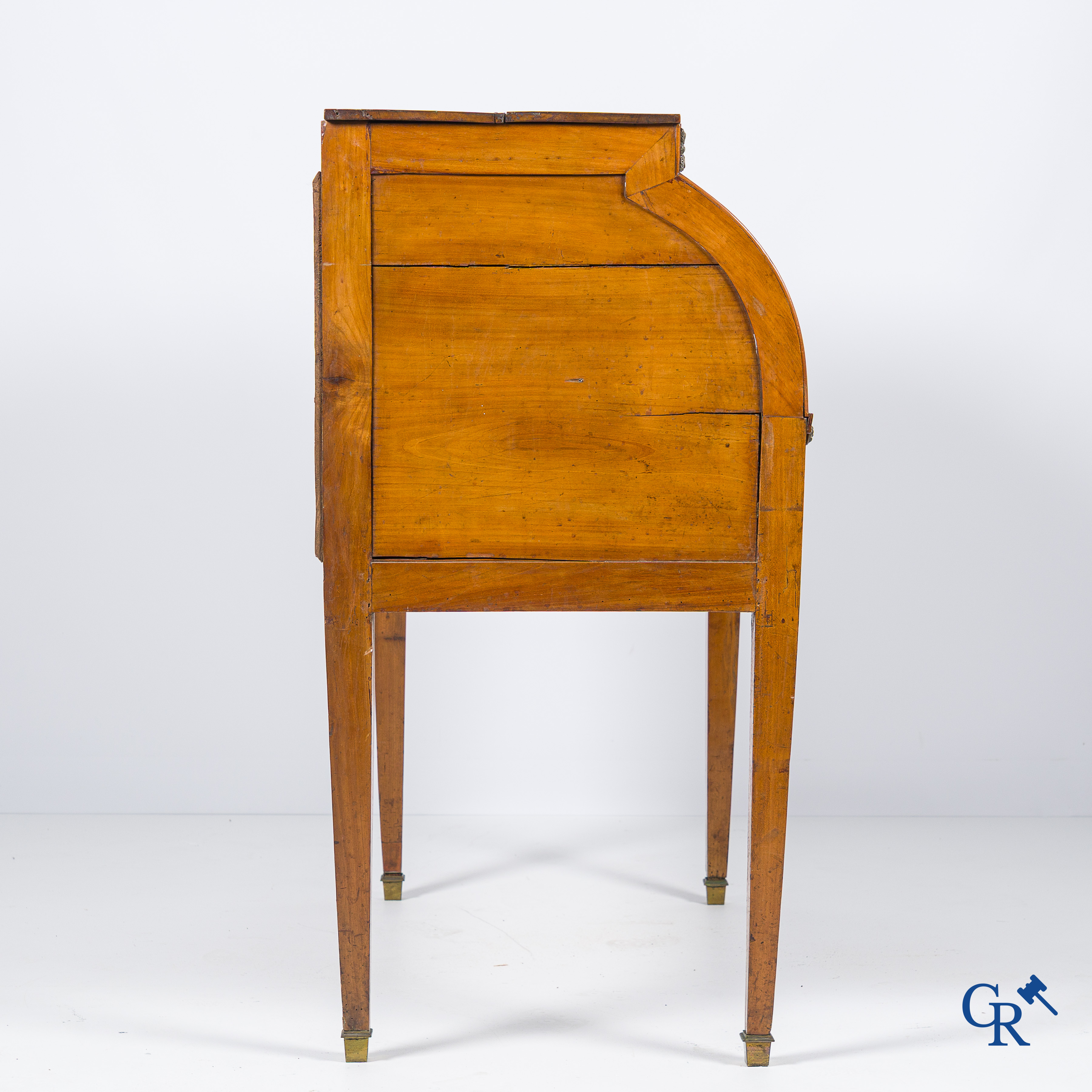 LXVI-period. A ladies cylinder desk in cherrywood and marquetry. France, end of the 18th century.