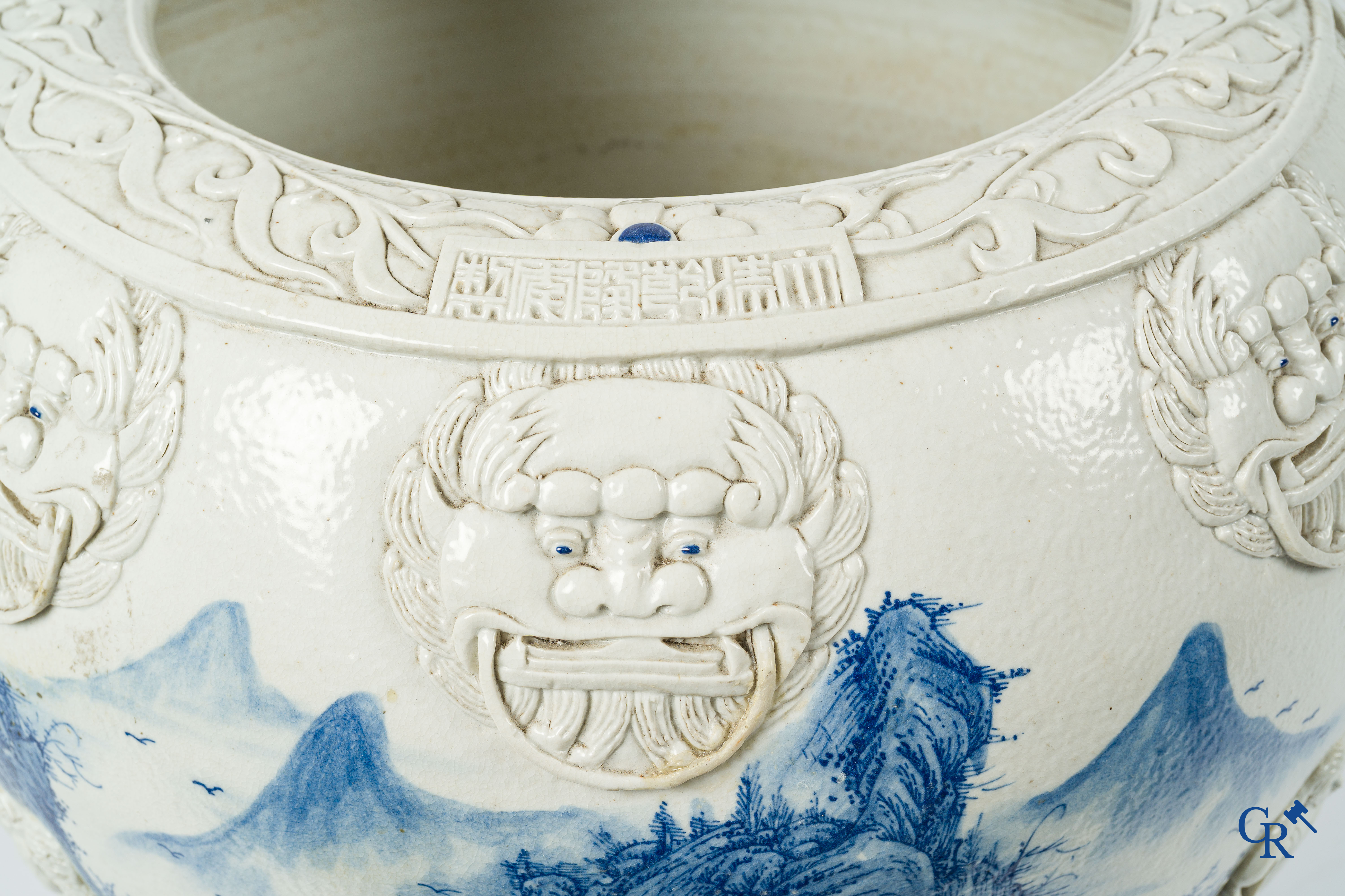 Aziatica. Oosters porselein. Grote cache pot, reliëfdecor op een blauw-wit landschap achtergrond. 19e eeuw.