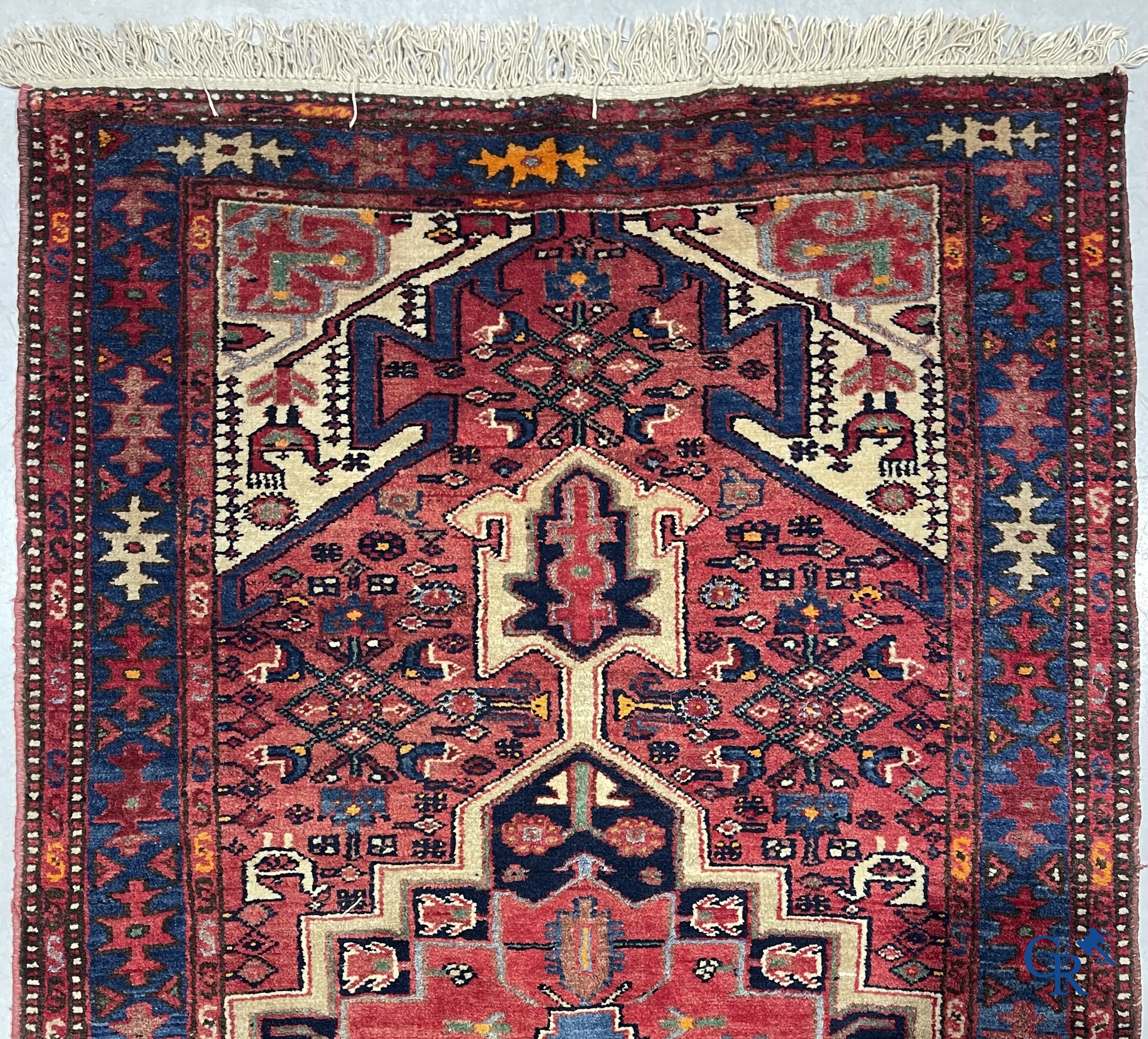 Oriental carpets. Antique hand-knotted Persian carpet with dark red background.