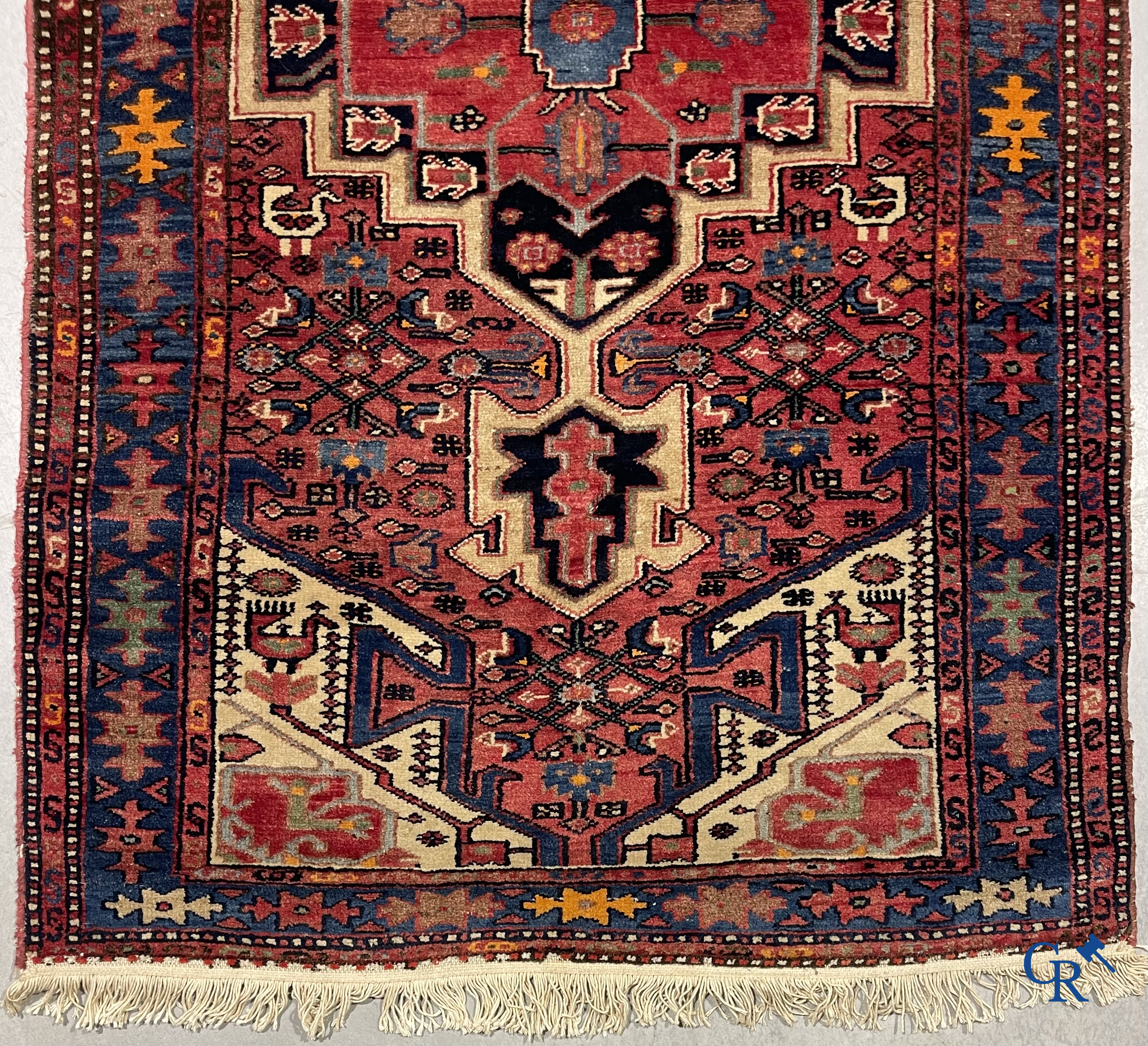 Oriental carpets. Antique hand-knotted Persian carpet with dark red background.