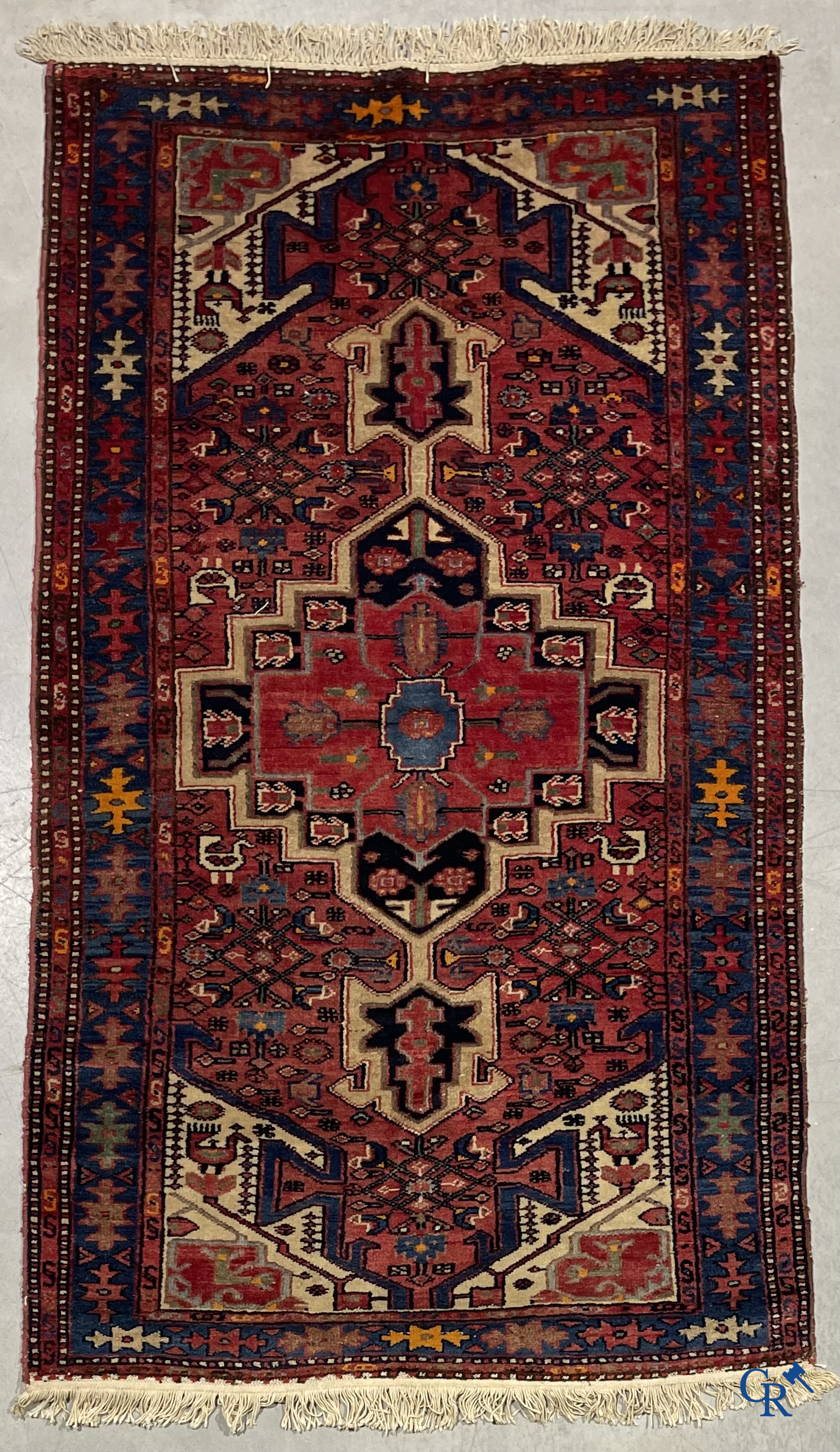 Oriental carpets. Antique hand-knotted Persian carpet with dark red background.