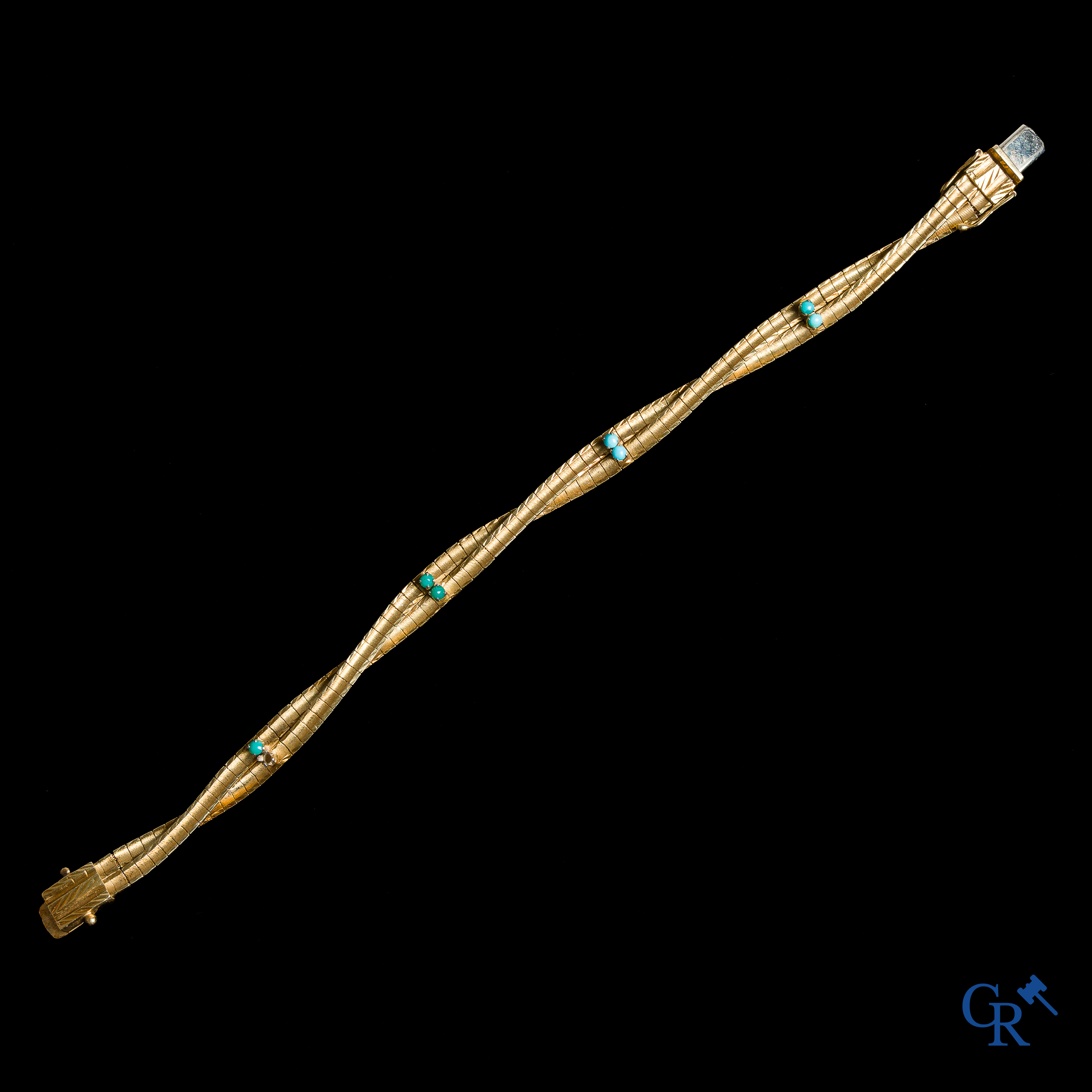 Juwelen. Armband in goud 750°/00 bezet met turquoise.