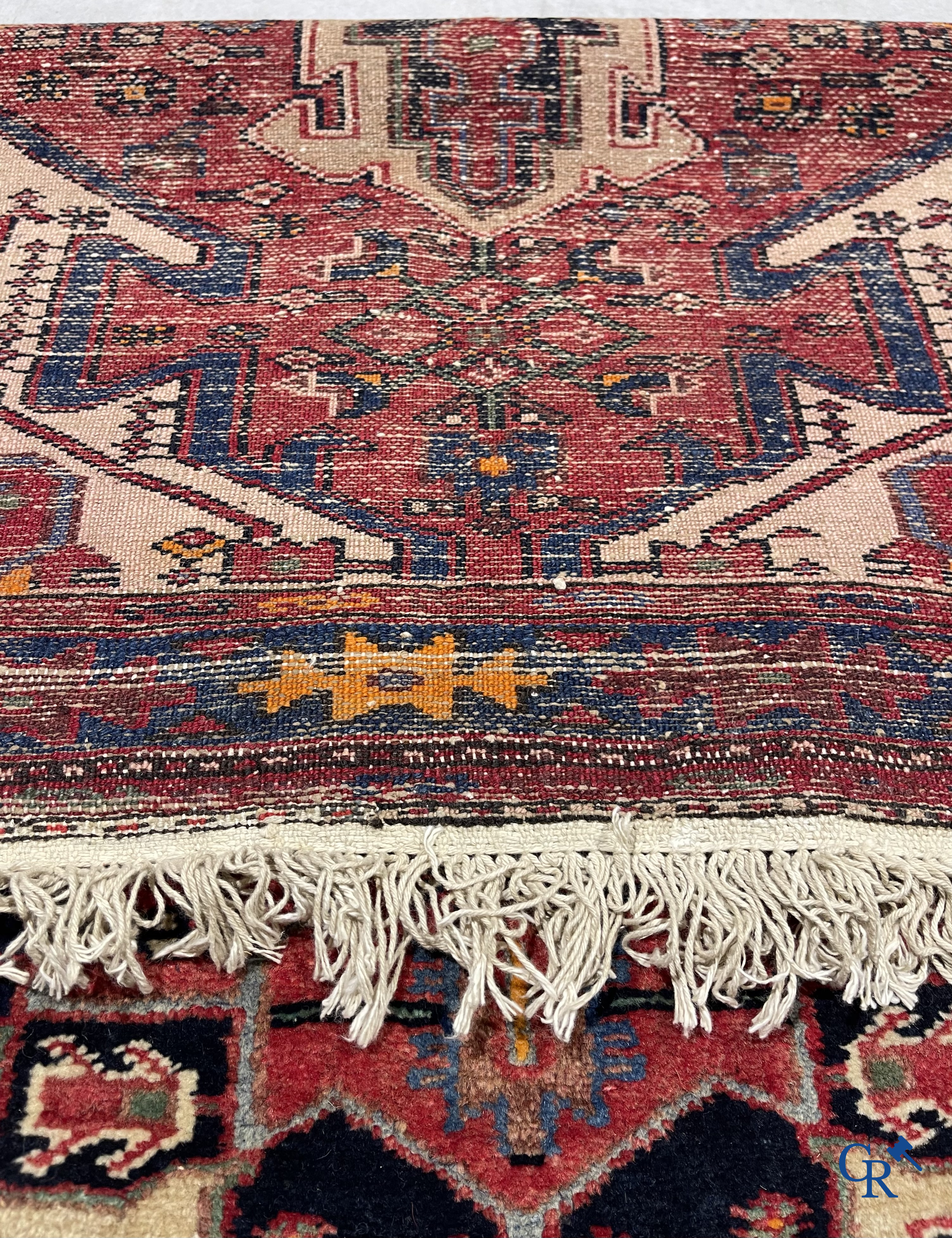Oriental carpets. Antique hand-knotted Persian carpet with dark red background.