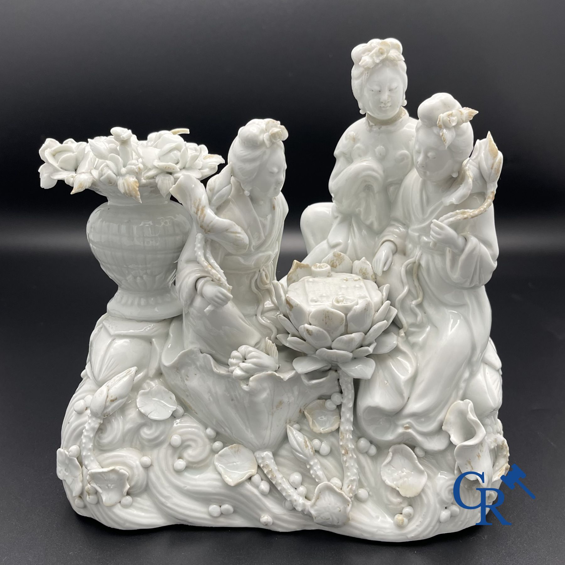 Chinese porcelain: A Buddhist lion and a group in blanc de Chine.