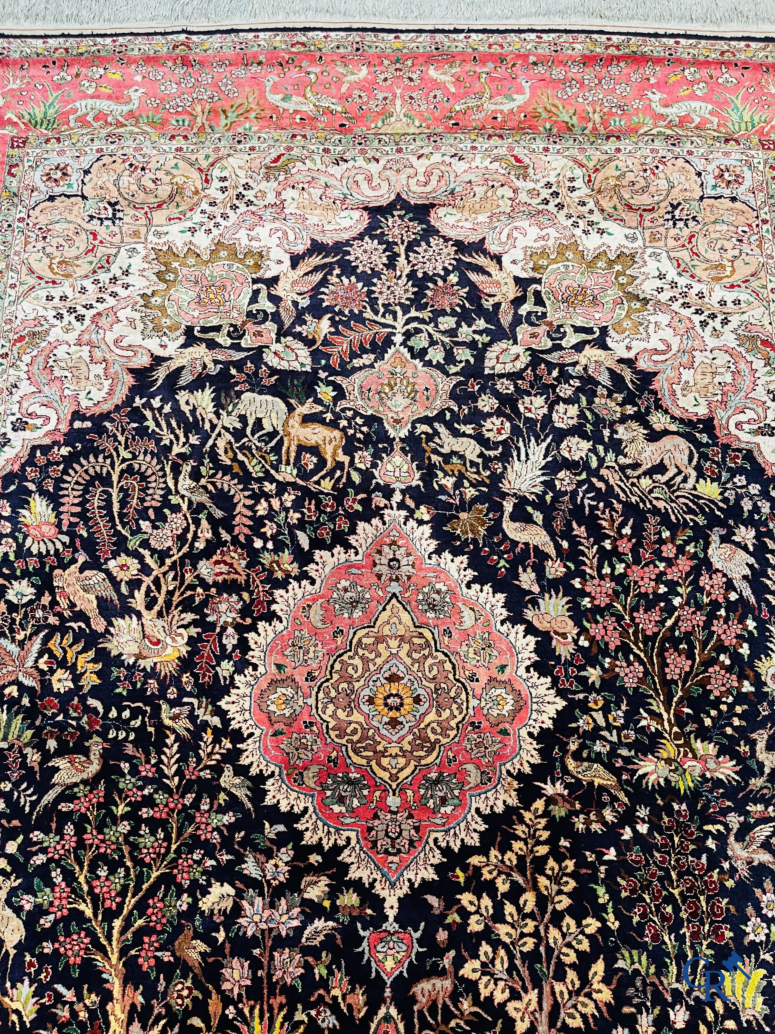 Oriental carpets: Tabriz, a finely hand-knotted silk carpet with forest animals and birds in a floral decor.