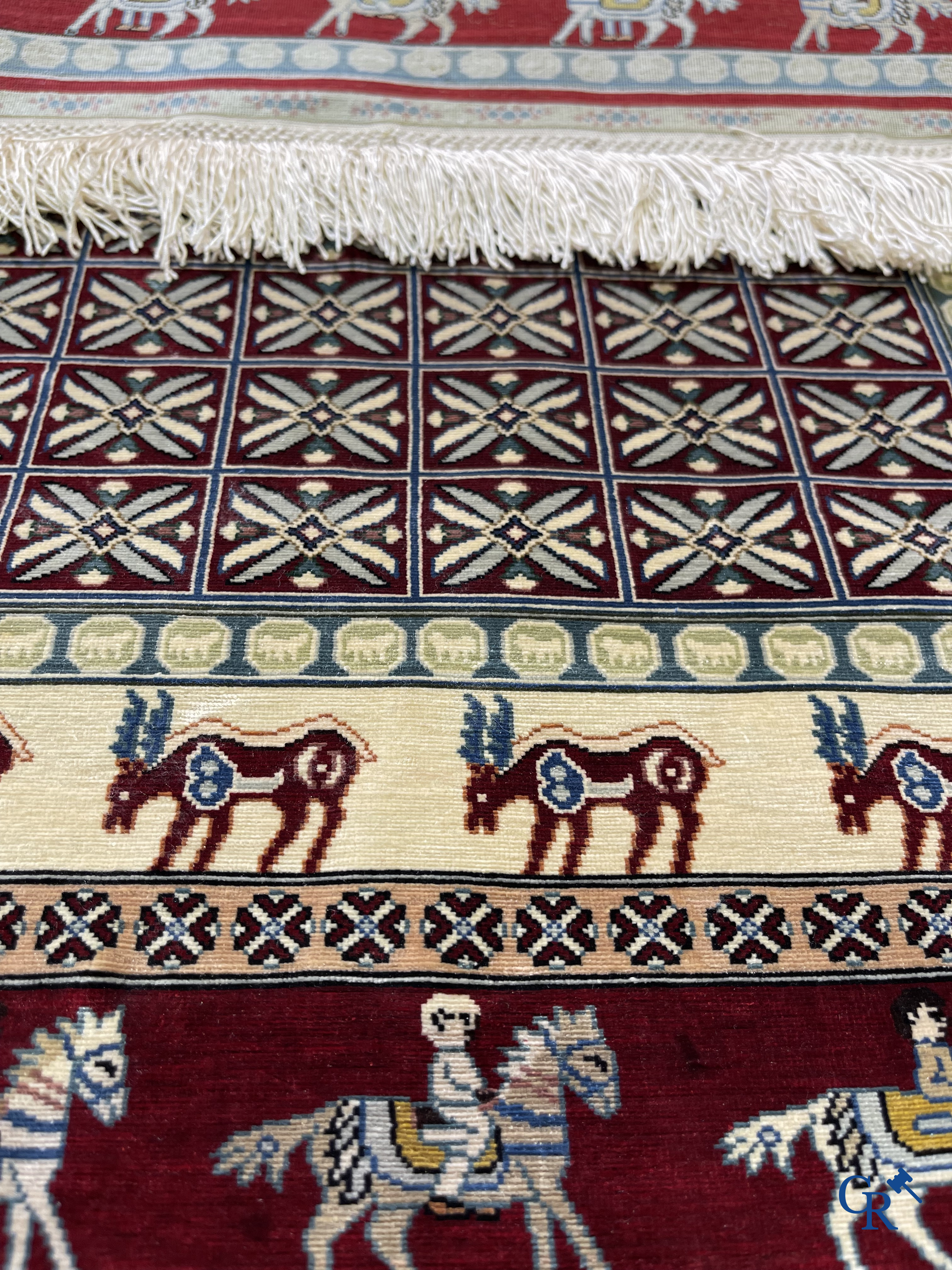 Oriental rugs: A small finely hand-knotted silk rug with deer and horsemen. Signed.