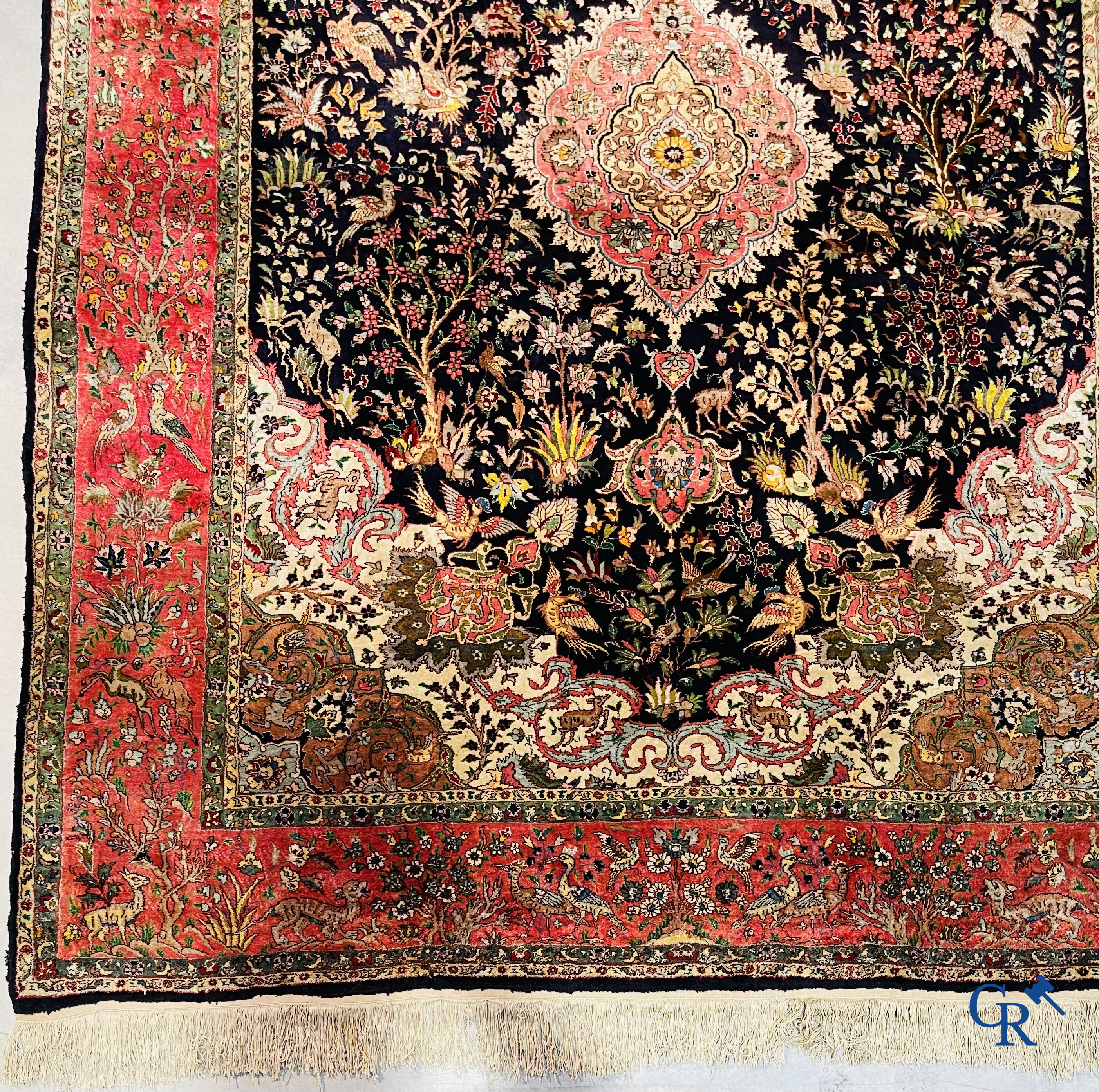 Oriental carpets: Tabriz, a finely hand-knotted silk carpet with forest animals and birds in a floral decor.