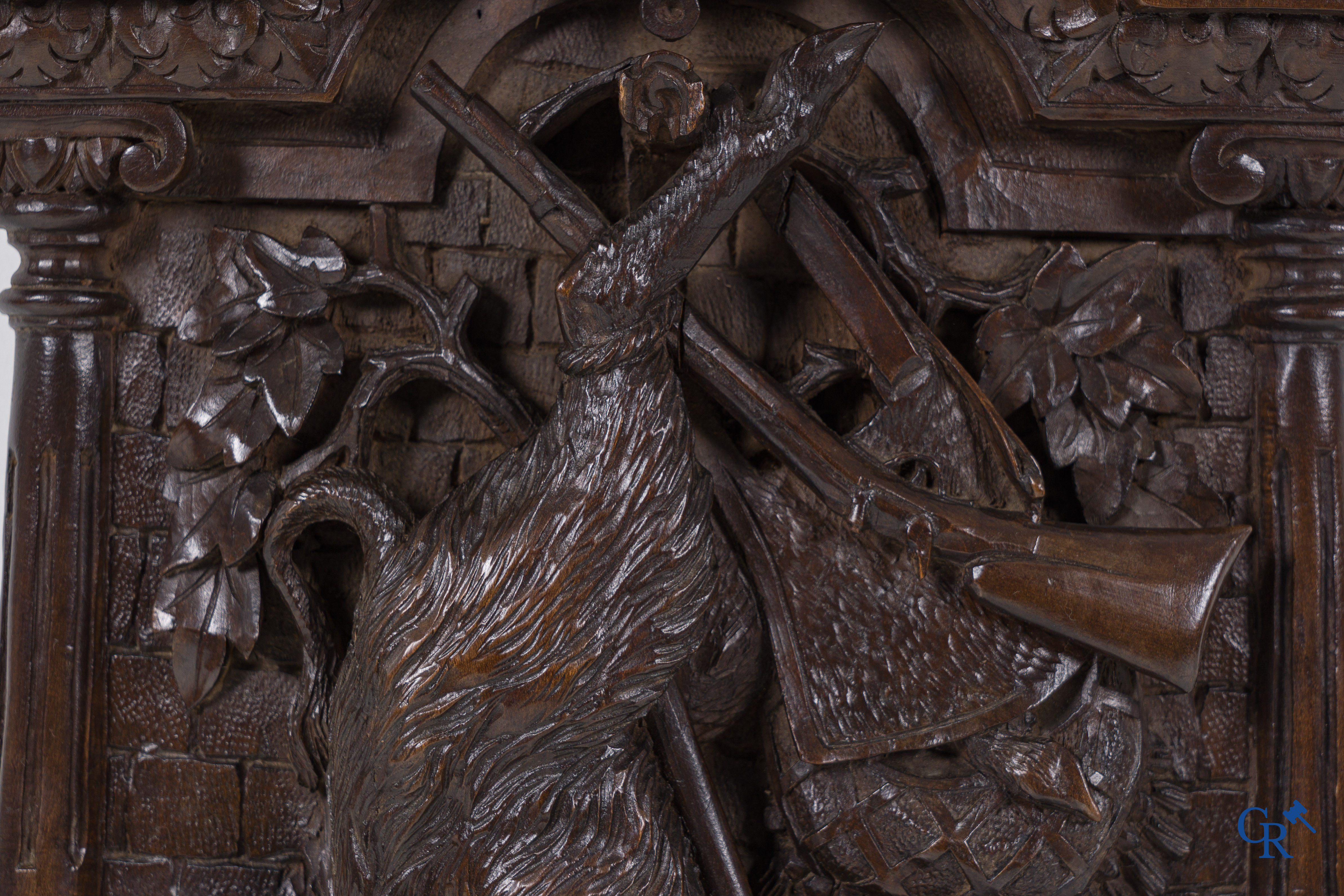 Black forest carvings. Key cabinet in richly sculpted wood with hunting scenes. Circa 1880.