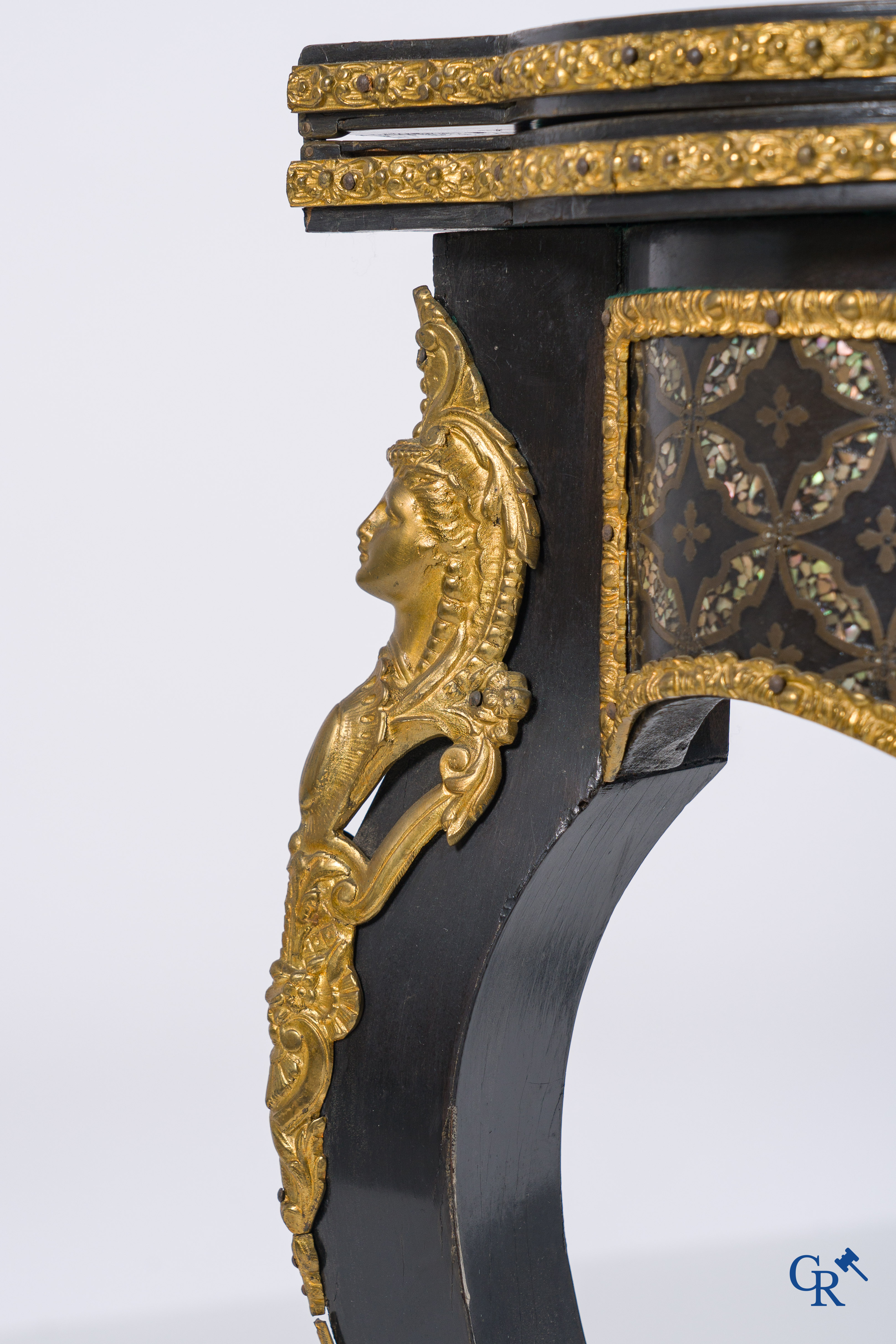 A card table with finely gilded bronze ornaments and inlay of copper and mother-of-pearl, circa 1880.