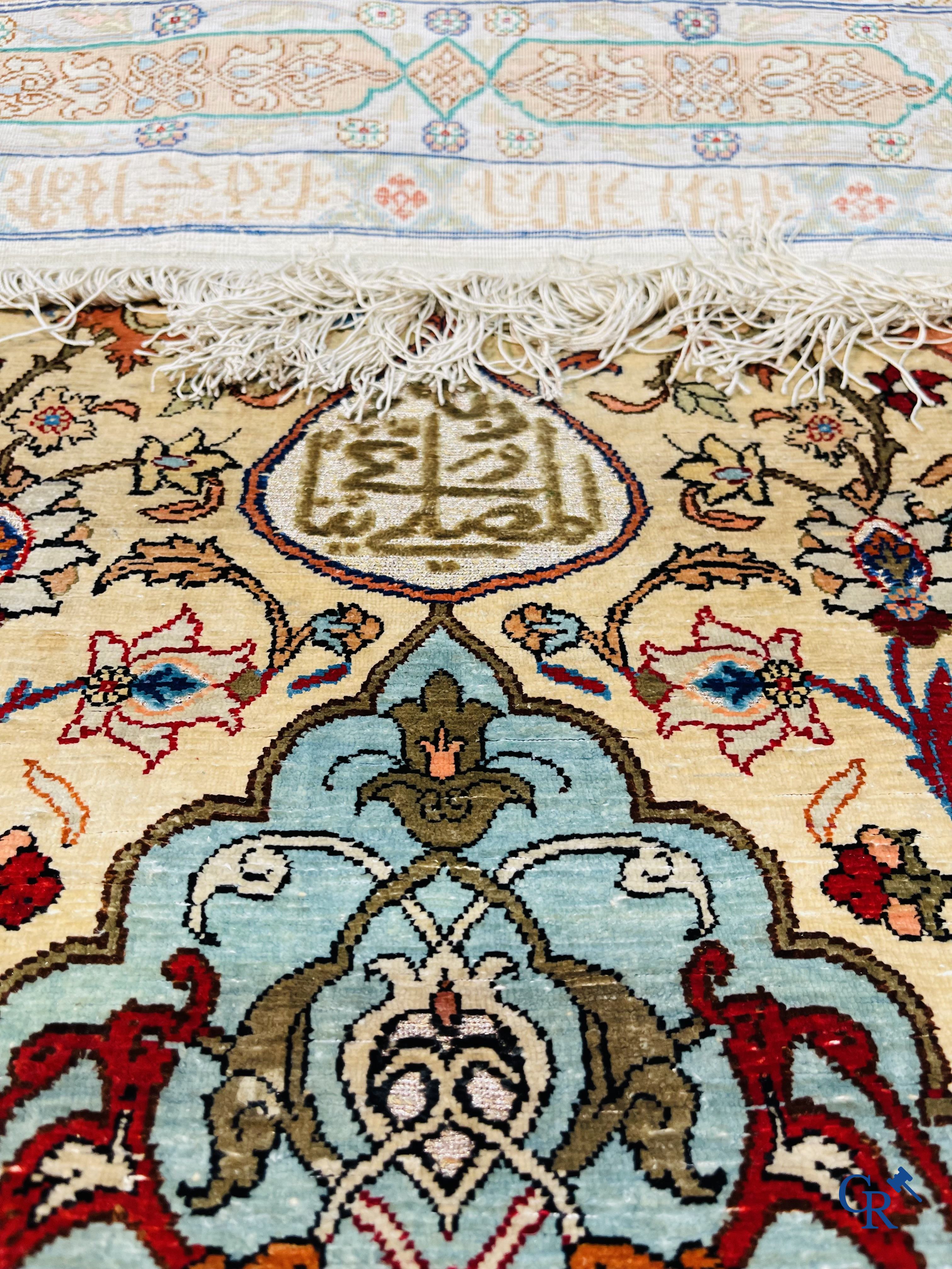 Oriental carpets, Hereke Turkey, a finely hand-knotted silk carpet with inscriptions and gold thread.