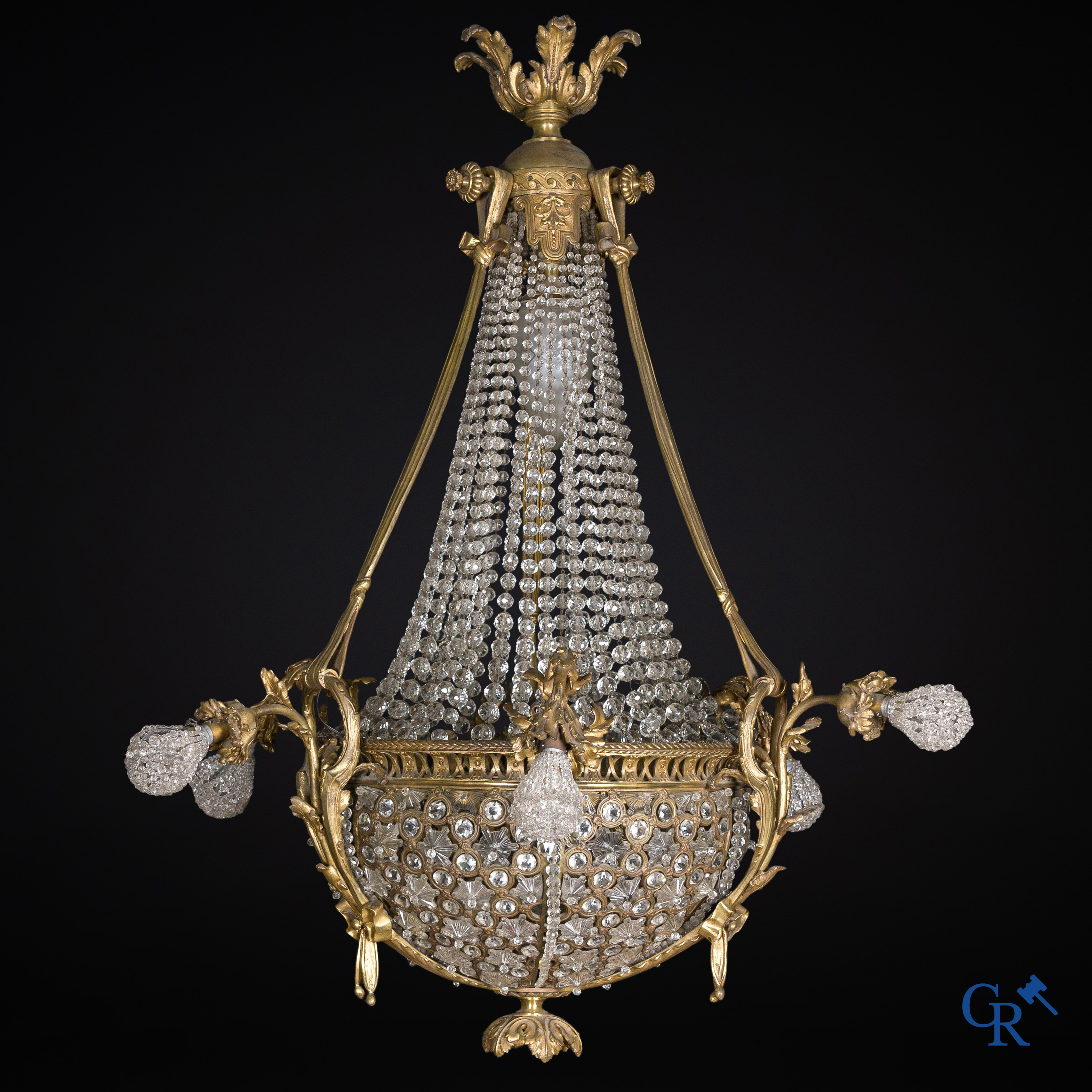 An imposing bronze and crystal chandelier in LXVI style. Circa 1920.