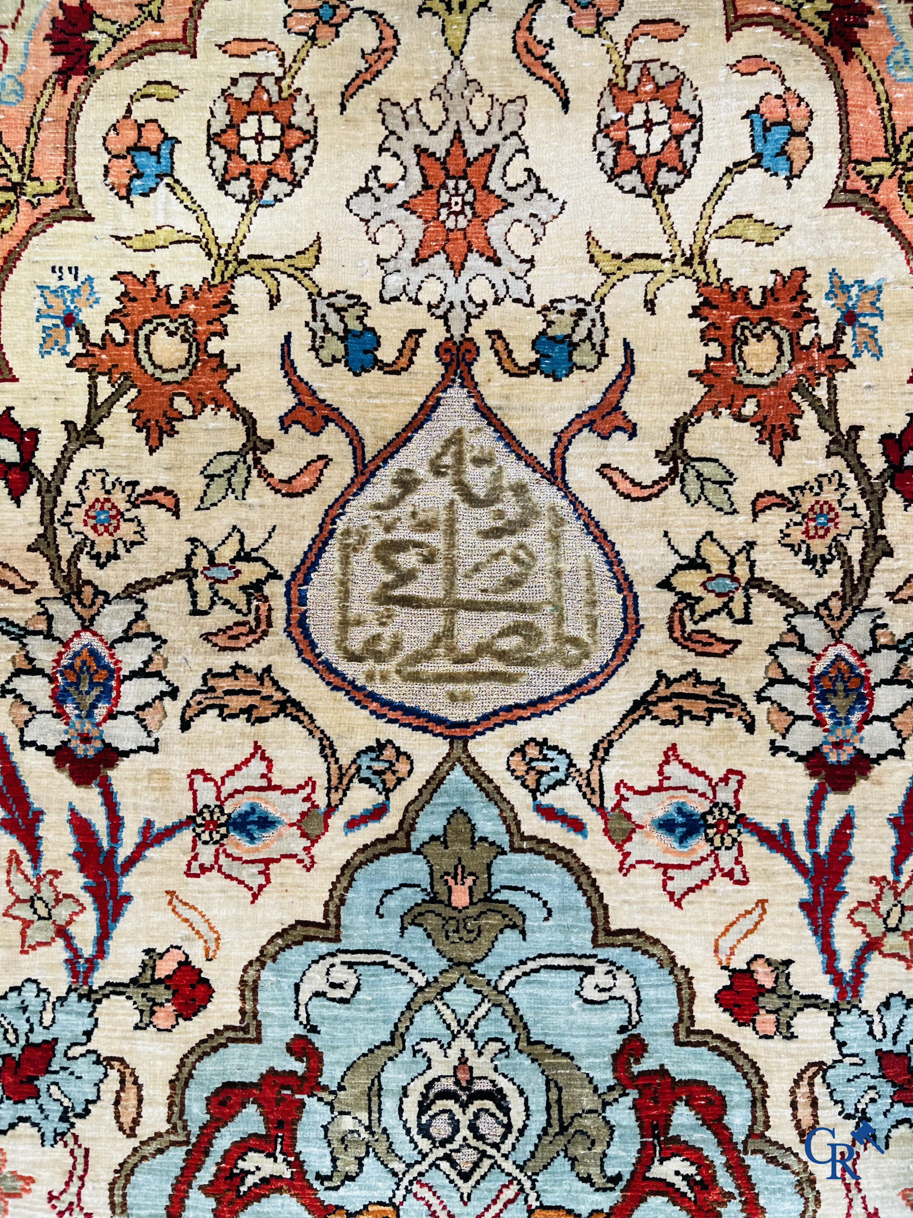 Oriental carpets, Hereke Turkey, a finely hand-knotted silk carpet with inscriptions and gold thread.