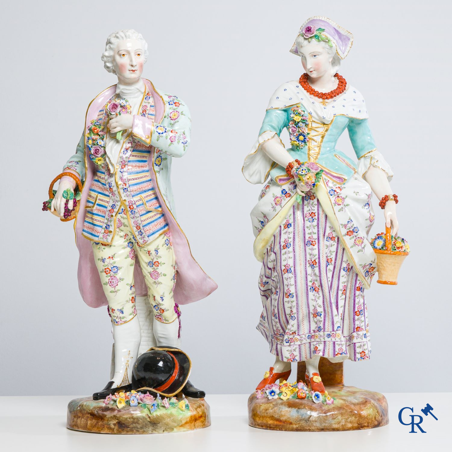 Exceptionally large pair of romantic statues in coloured and gilded porcelain in the manner of Meissen.