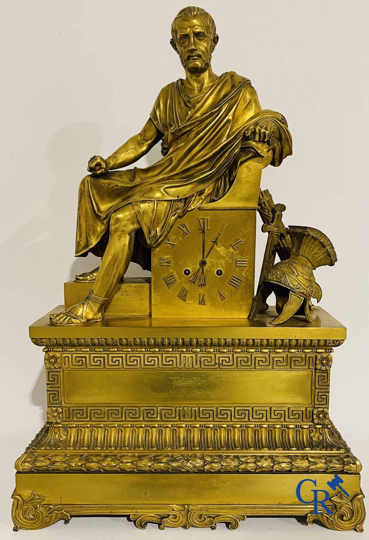 Imposing fire-gilded empire pendulum depicting a seated Roman emperor.