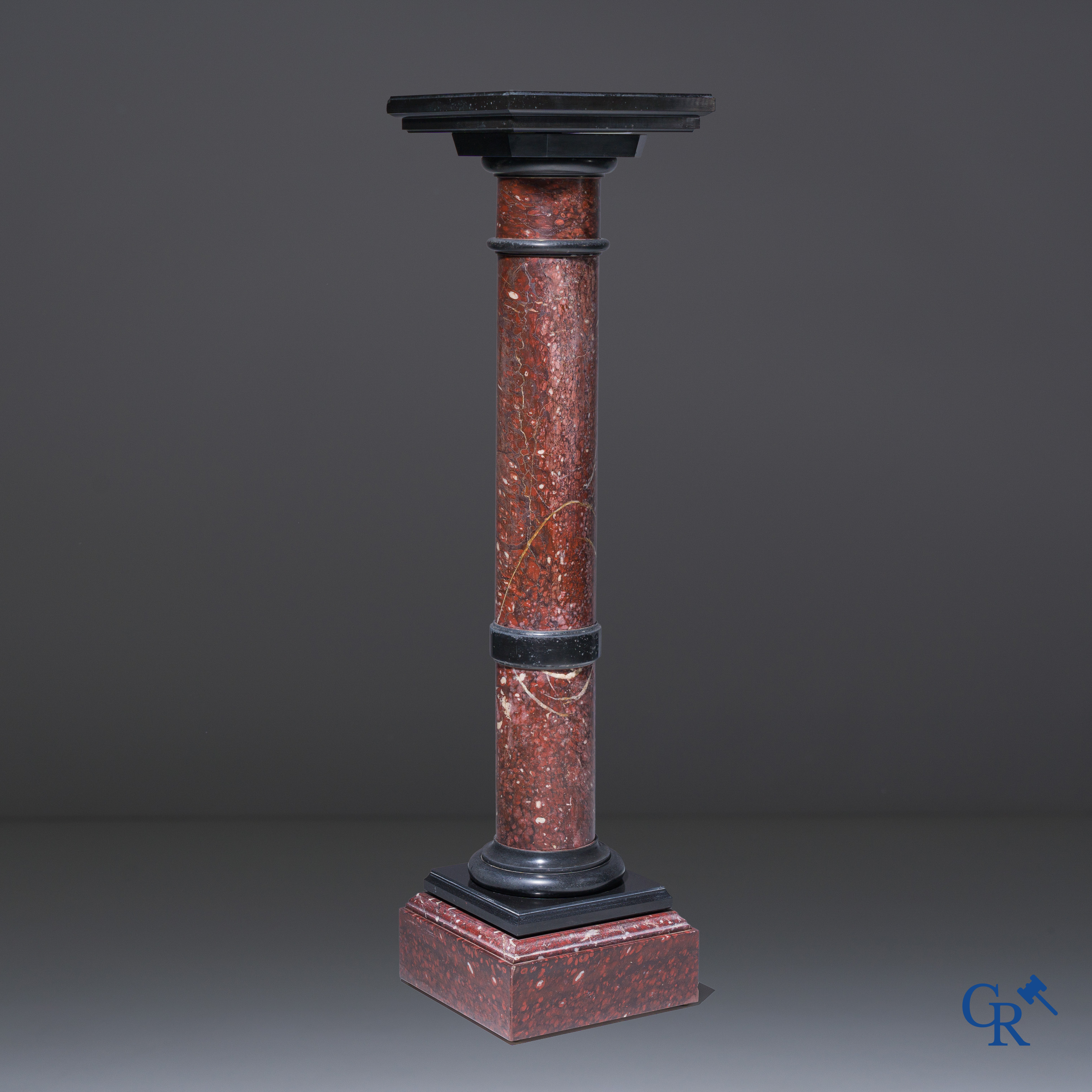 A pedestal in black and red veined Belgian marble with pivoting platform. Circa 1930.