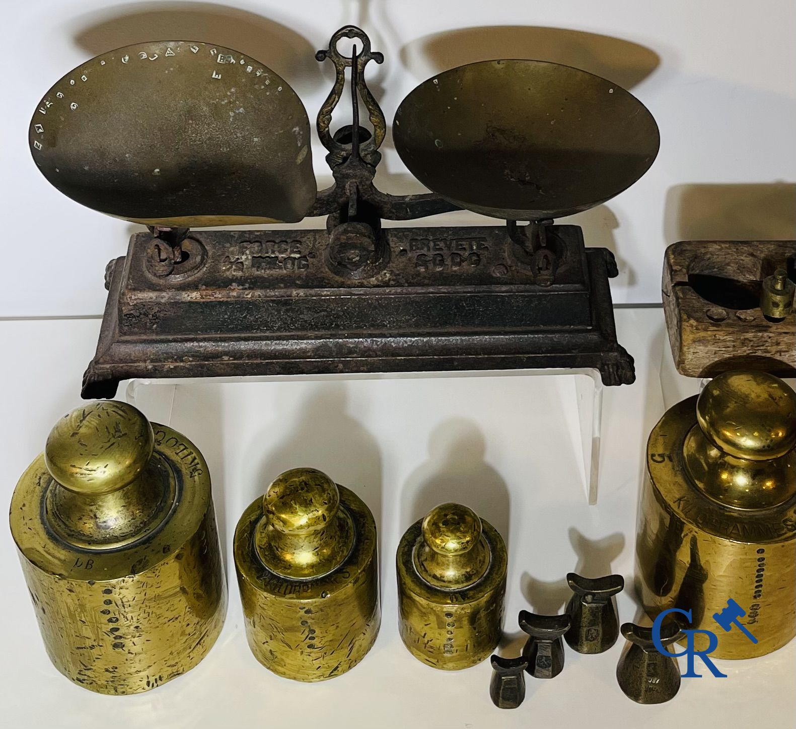 A various lot of antique calibration weights and a calibrated scale. 18th-19th century.