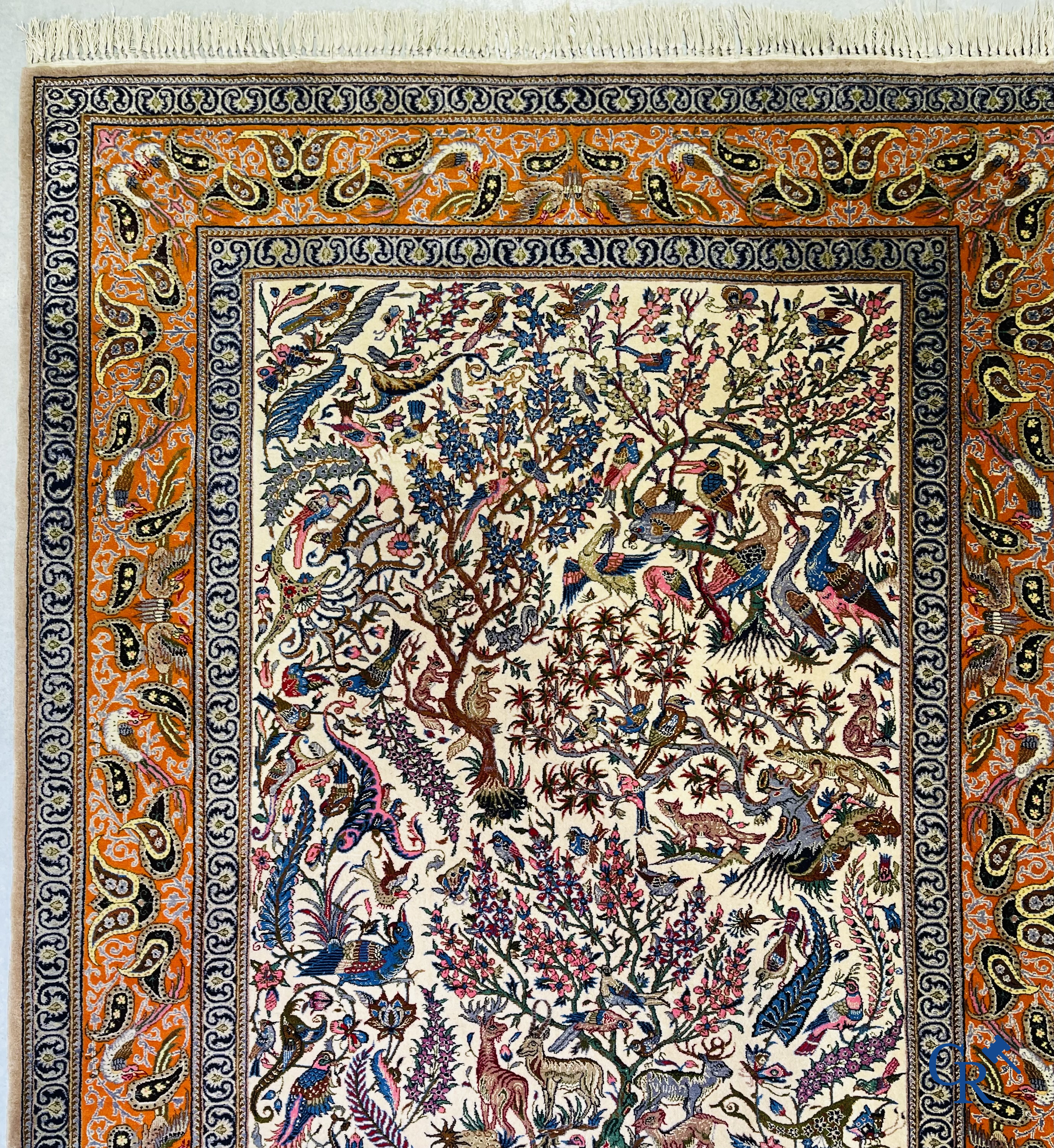 Oriental carpets, a finely hand-knotted silk carpet with forest animals. Signed.