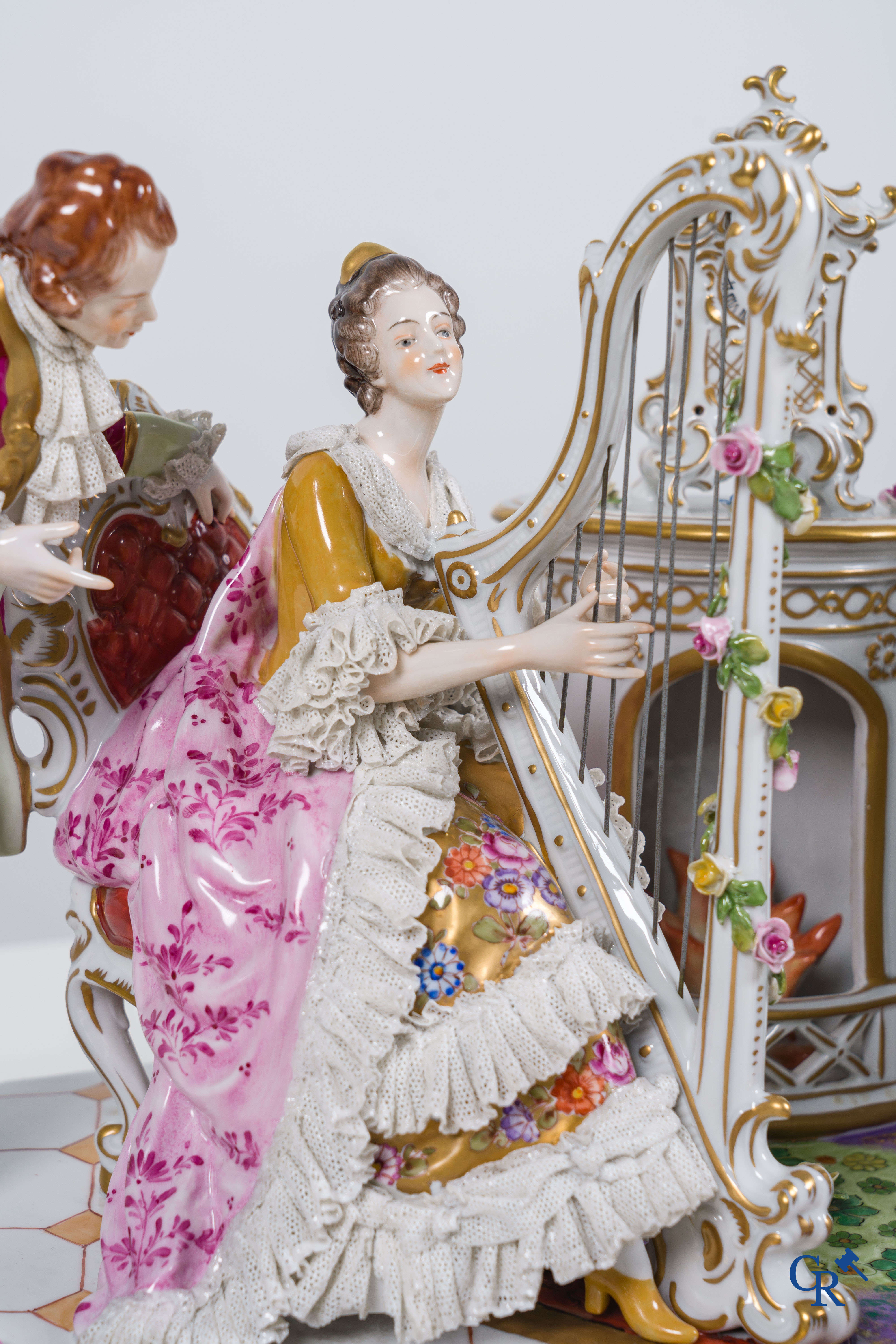 Volkstedt Rudolstadt, Large group in lace porcelain, harp playing lady in a richly decorated interior. Marked.