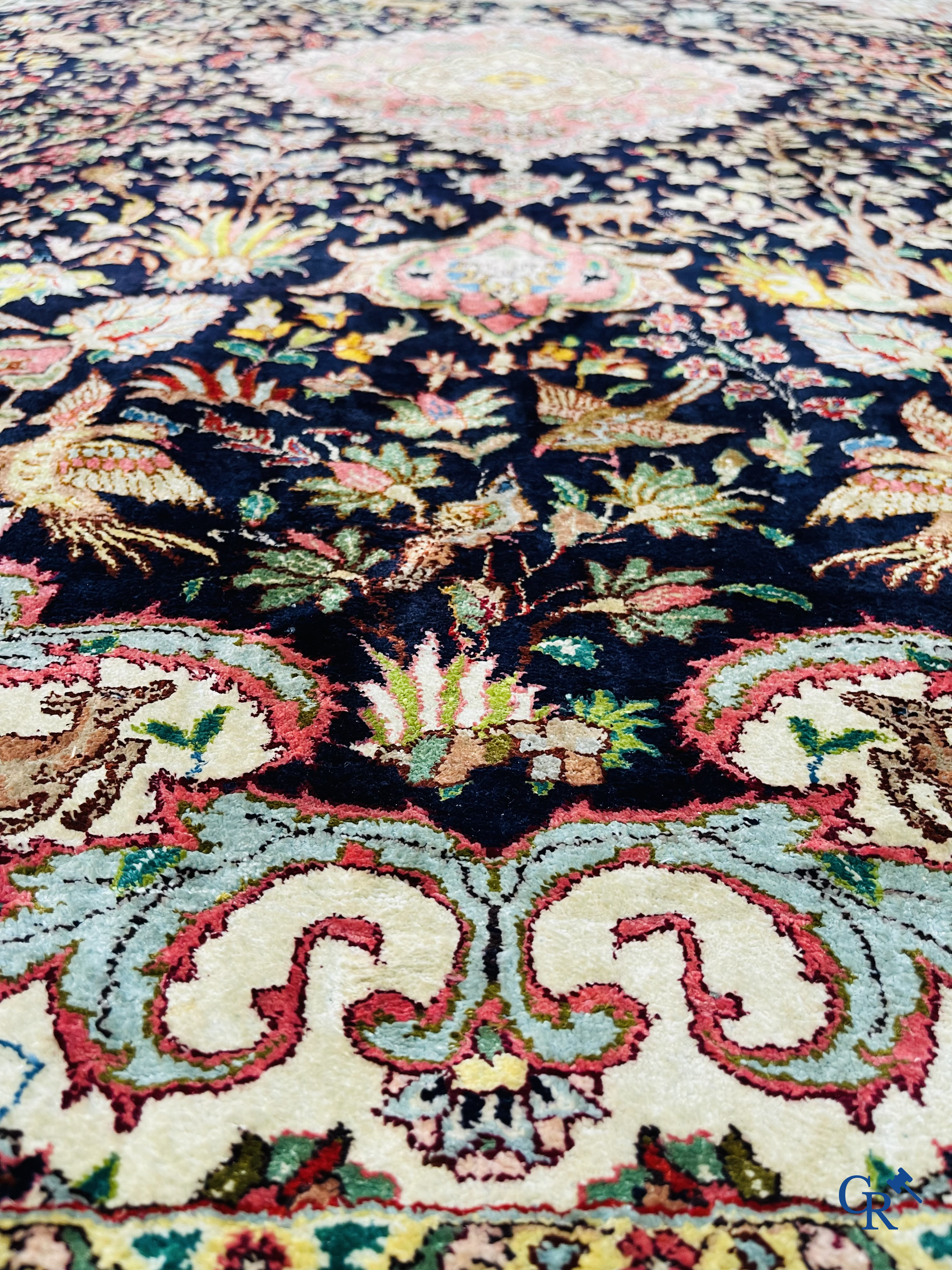 Oriental carpets: Tabriz, a finely hand-knotted silk carpet with forest animals and birds in a floral decor.