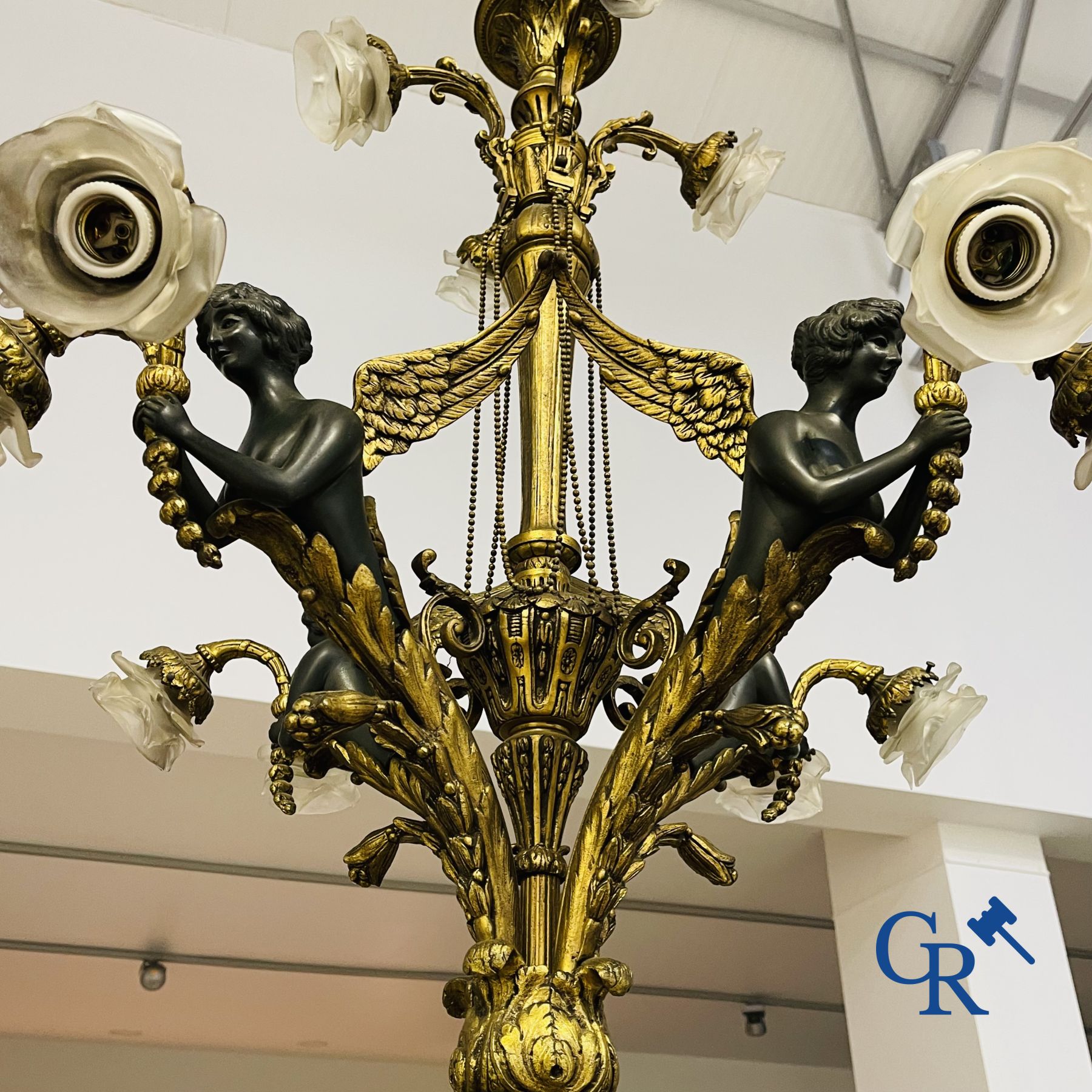 Chandelier: A large bronze chandelier in empire style. Period 1920.