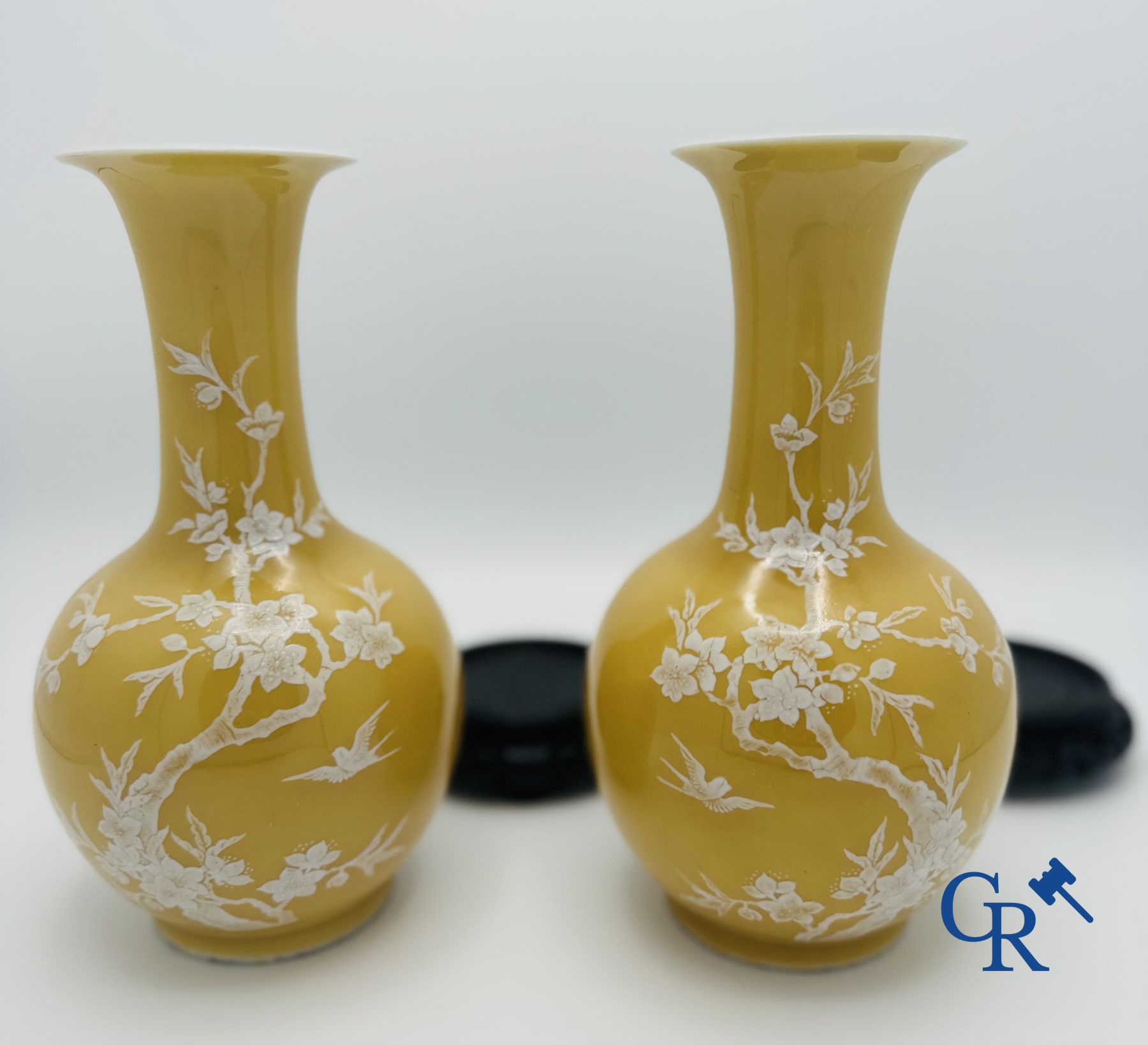 Chinese porcelain: Pair of Chinese vases with a floral decor on a yellow glazed surface. 20th century.