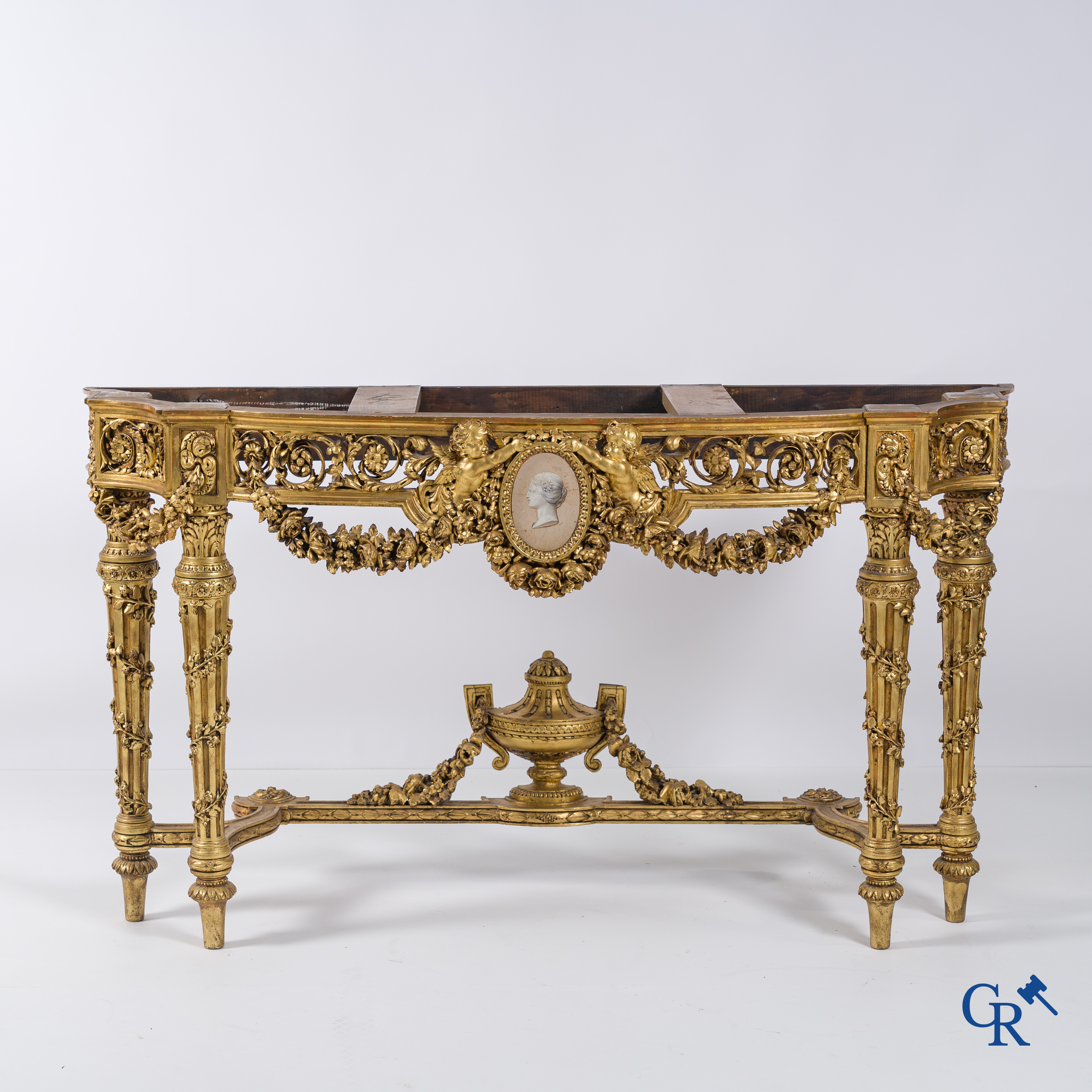 A richly carved and gilded console table in LVXI style with a grisaille painting on marble.