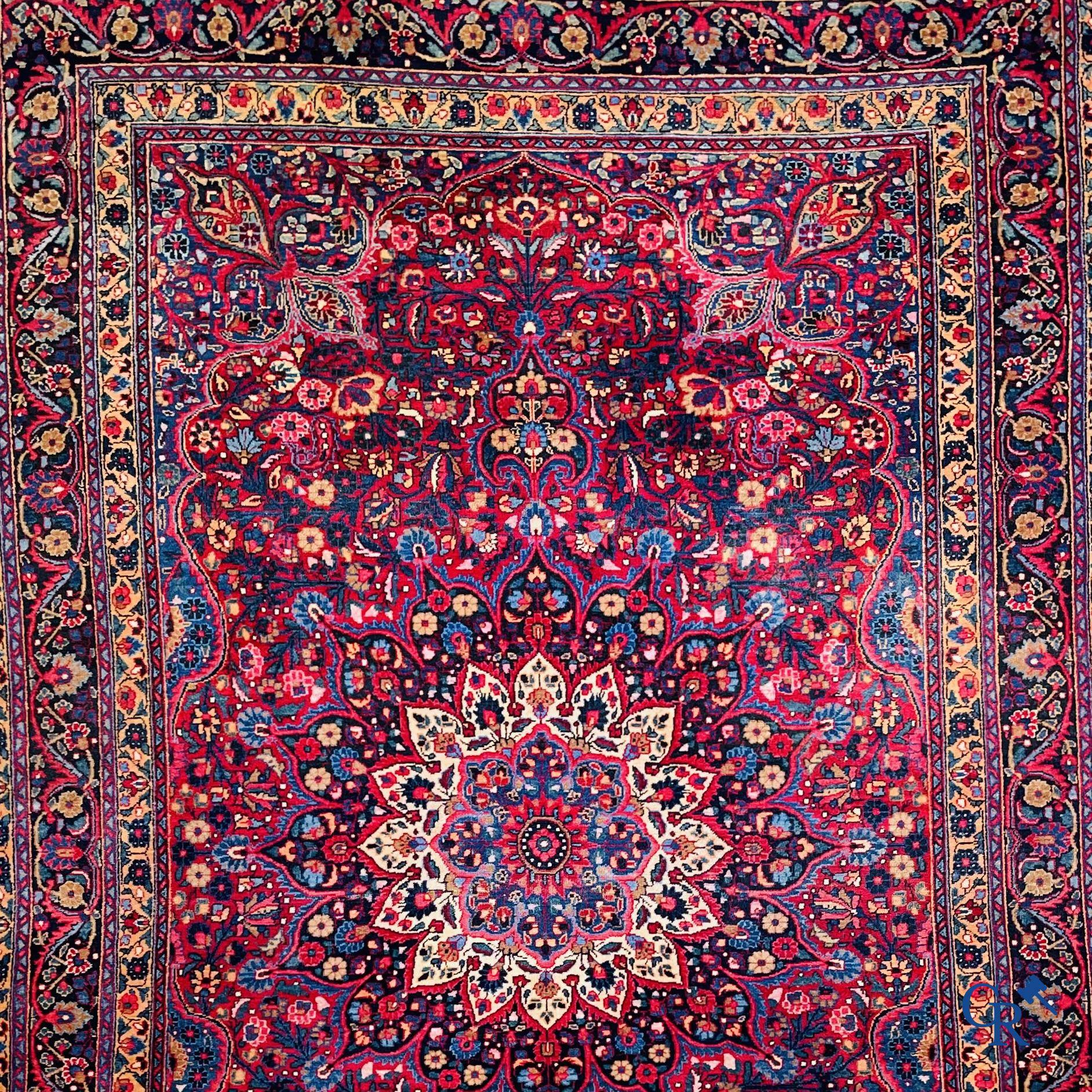 Oriental carpets: Iran, antique Persian carpet with dark red background.