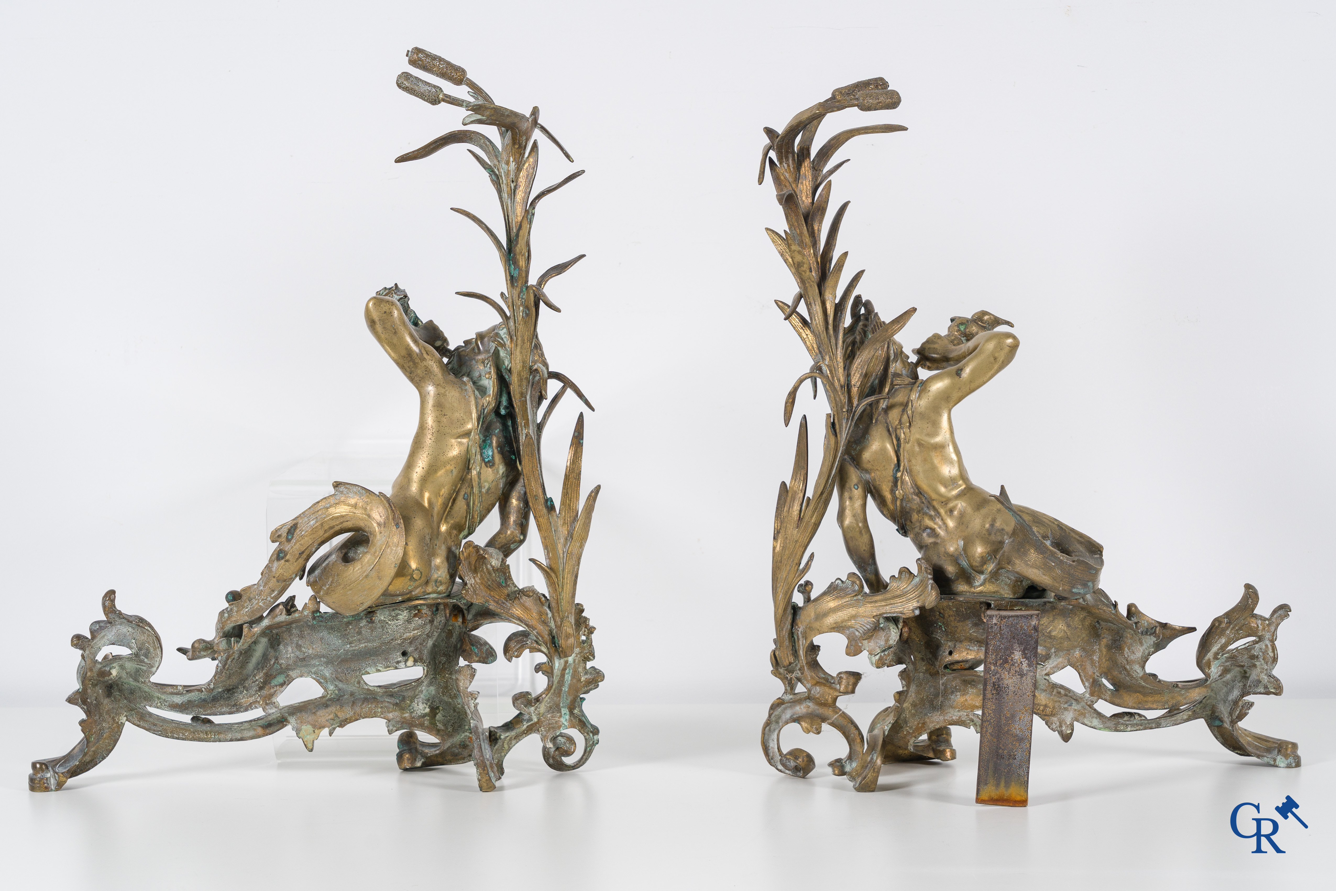 A large pair of finely chiseled bronze chenets with Tritons. Louis XV style. Napoleon III period.