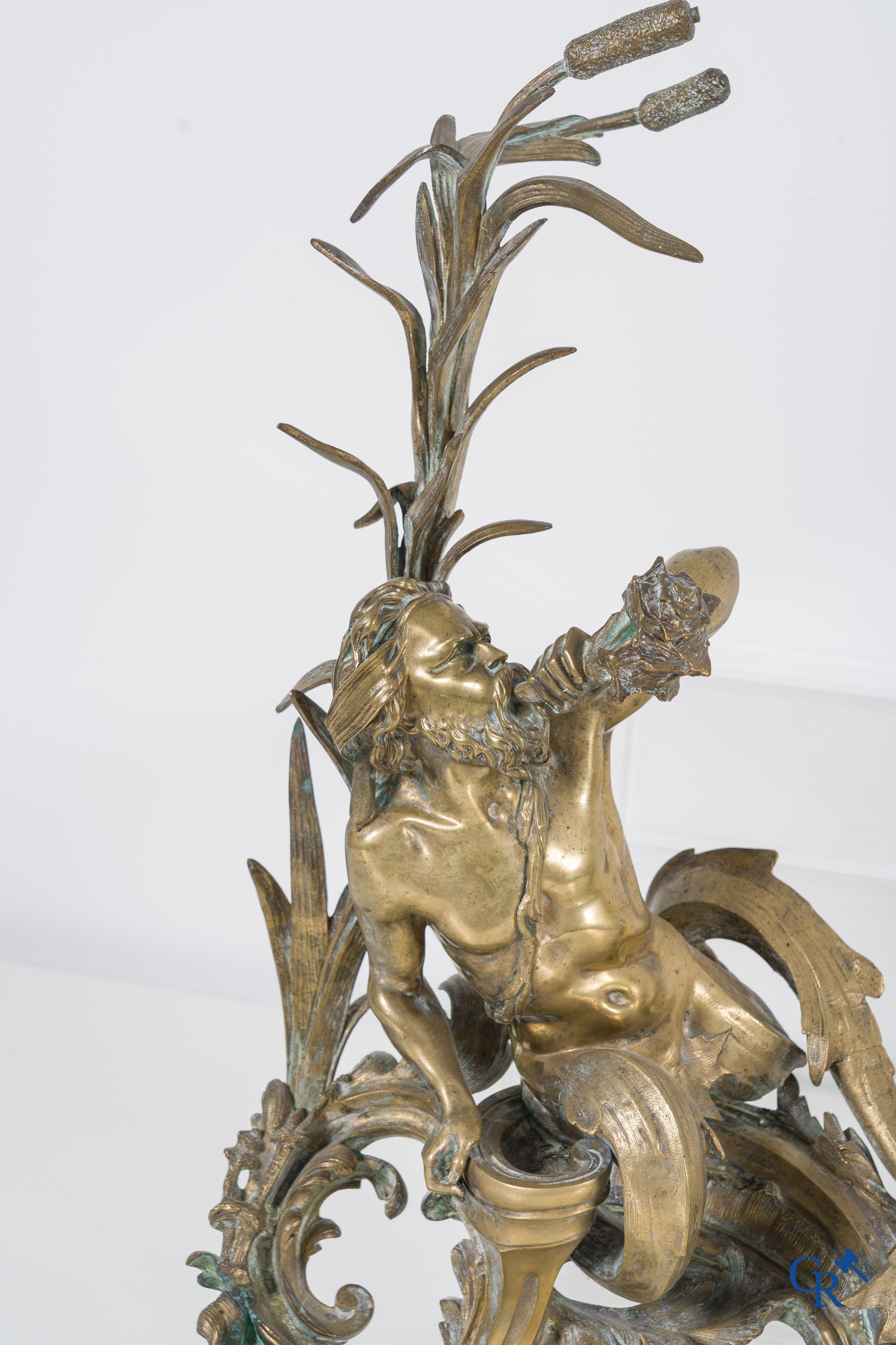 A large pair of finely chiseled bronze chenets with Tritons. Louis XV style. Napoleon III period.