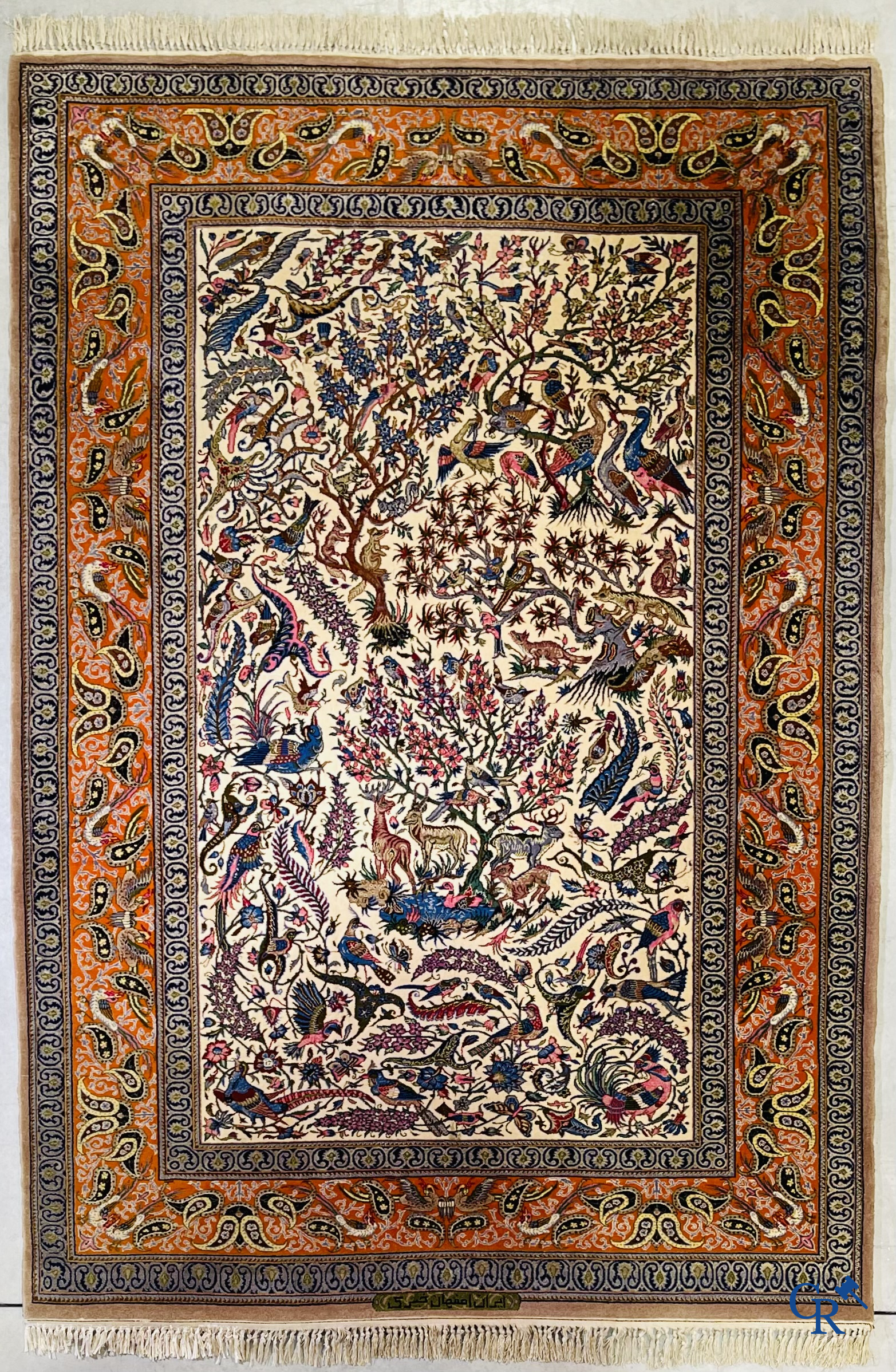 Oriental carpets, a finely hand-knotted silk carpet with forest animals. Signed.